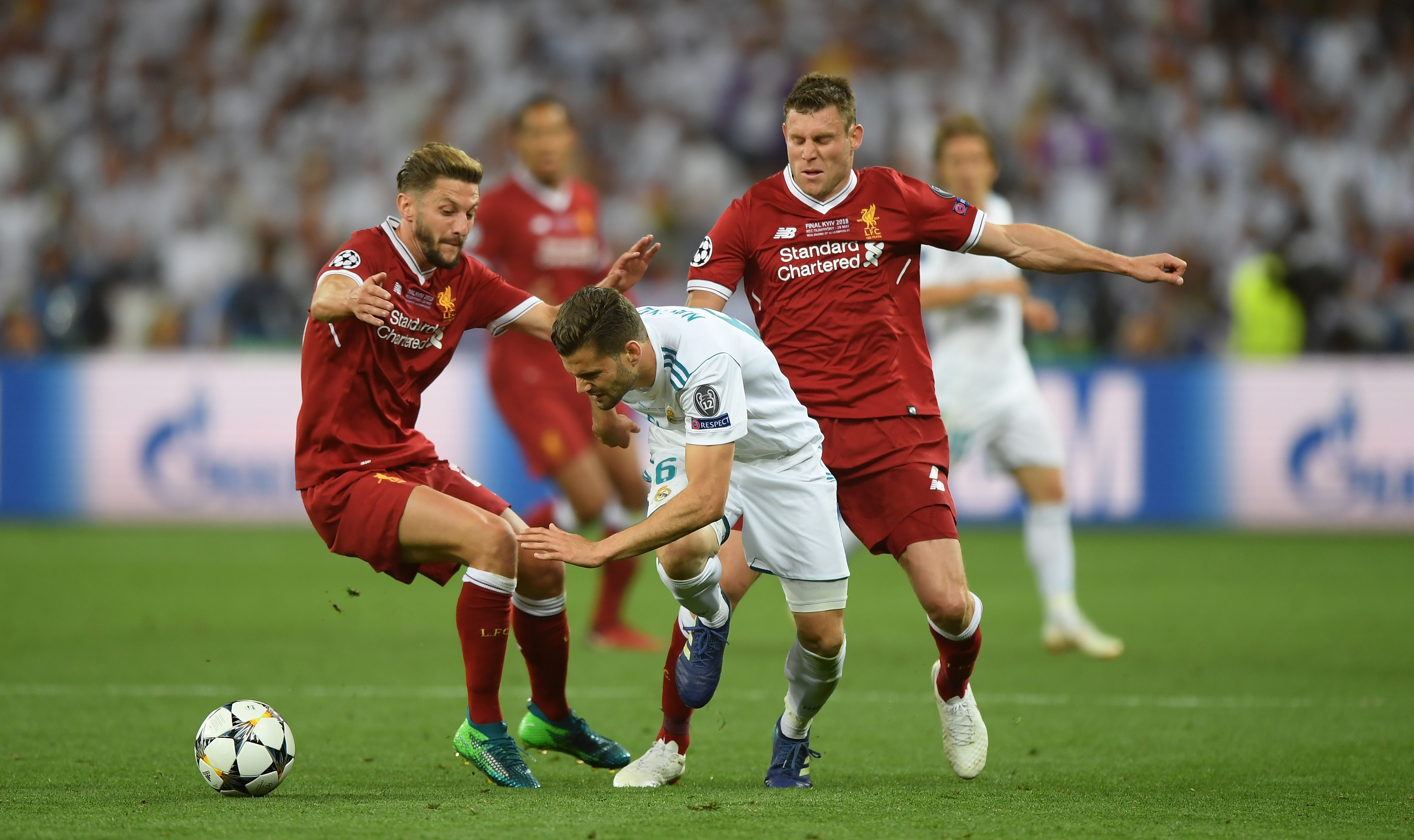 KIEV, UKRAINE - MAY 26: Nacho Fernandez of Real Madrid, James Milner and Adam Lallana of Liverpool compete for the ball during the UEFA Champions League Final between Real Madrid and Liverpool at NSC Olimpiyskiy Stadium on May 26, 2018 in Kiev, Ukraine. (Photo by Shaun Botterill/Getty Images)