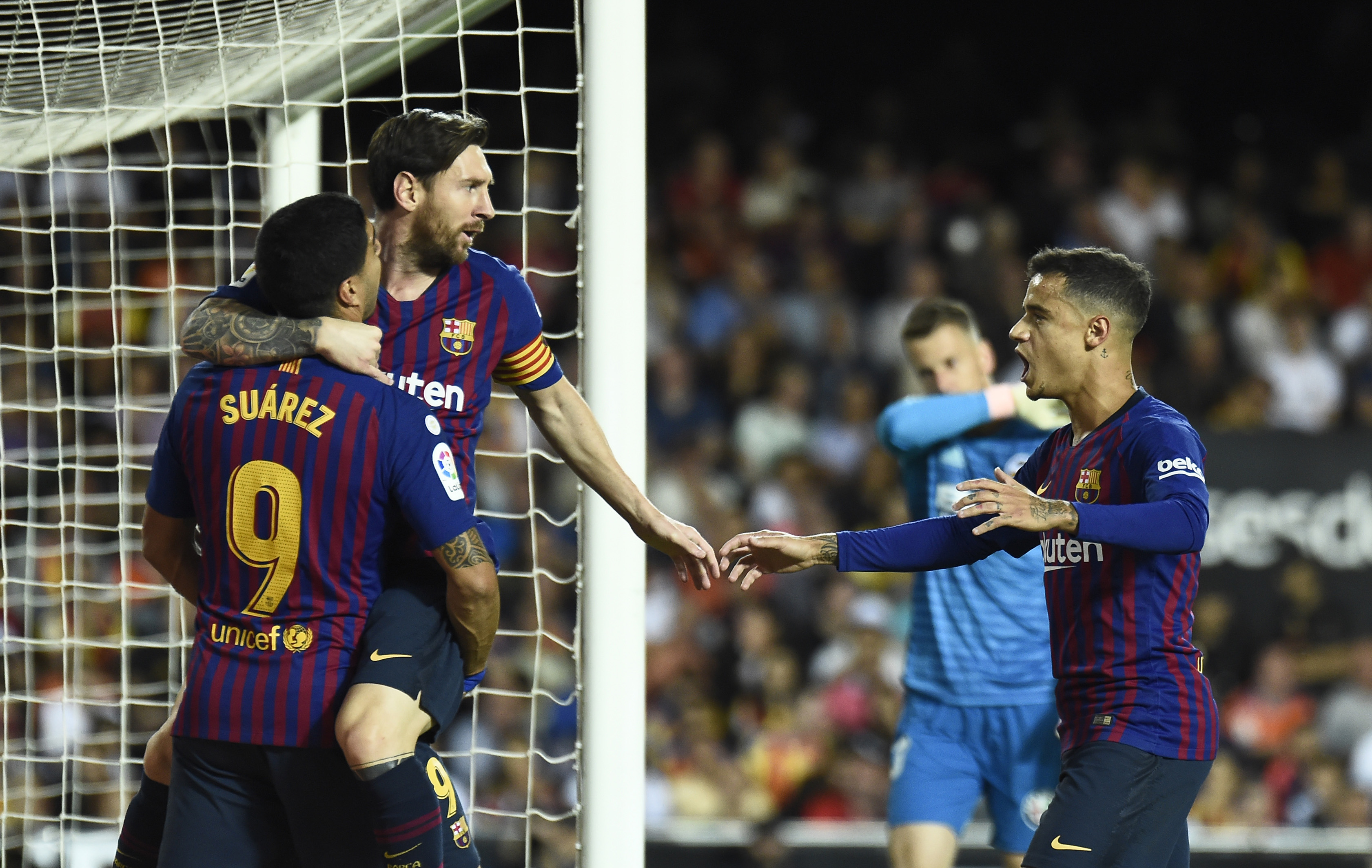 Barcelona's Argentinian forward Lionel Messi (TOP L) celebrates after scoring a goal with Barcelona's Uruguayan forward Luis Suarez and Barcelona's Brazilian midfielder Coutinho (R) during the Spanish league football match between Valencia CF and FC Barcelona at the Mestalla stadium in Valencia on October 7, 2018. (Photo by JOSE JORDAN / AFP) (Photo credit should read JOSE JORDAN/AFP/Getty Images)