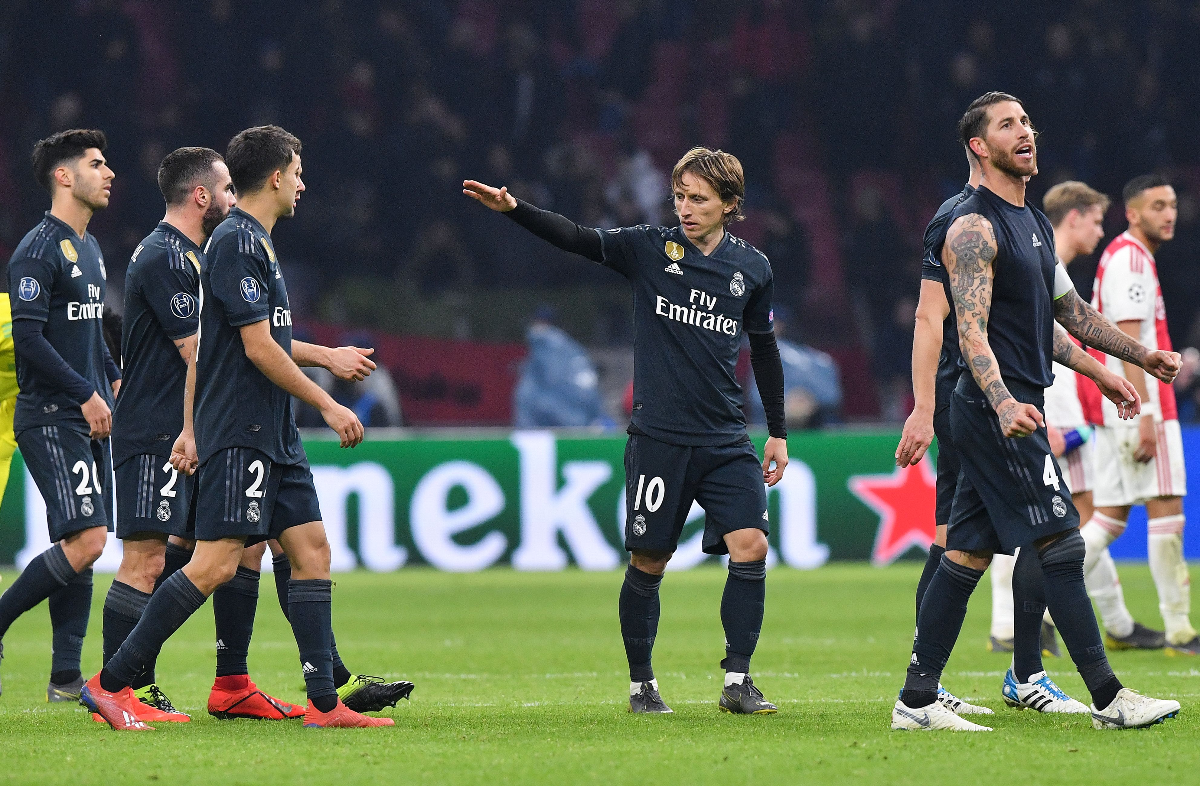 Real Madrid's Luka Modric (C) celebrates with teammates during the UEFA Champions league round of 16 first leg football match between Ajax Amsterdam and Real Madrid at the Johan Cruijff ArenA on February 13, 2019. (Photo by EMMANUEL DUNAND / AFP) (Photo credit should read EMMANUEL DUNAND/AFP/Getty Images)