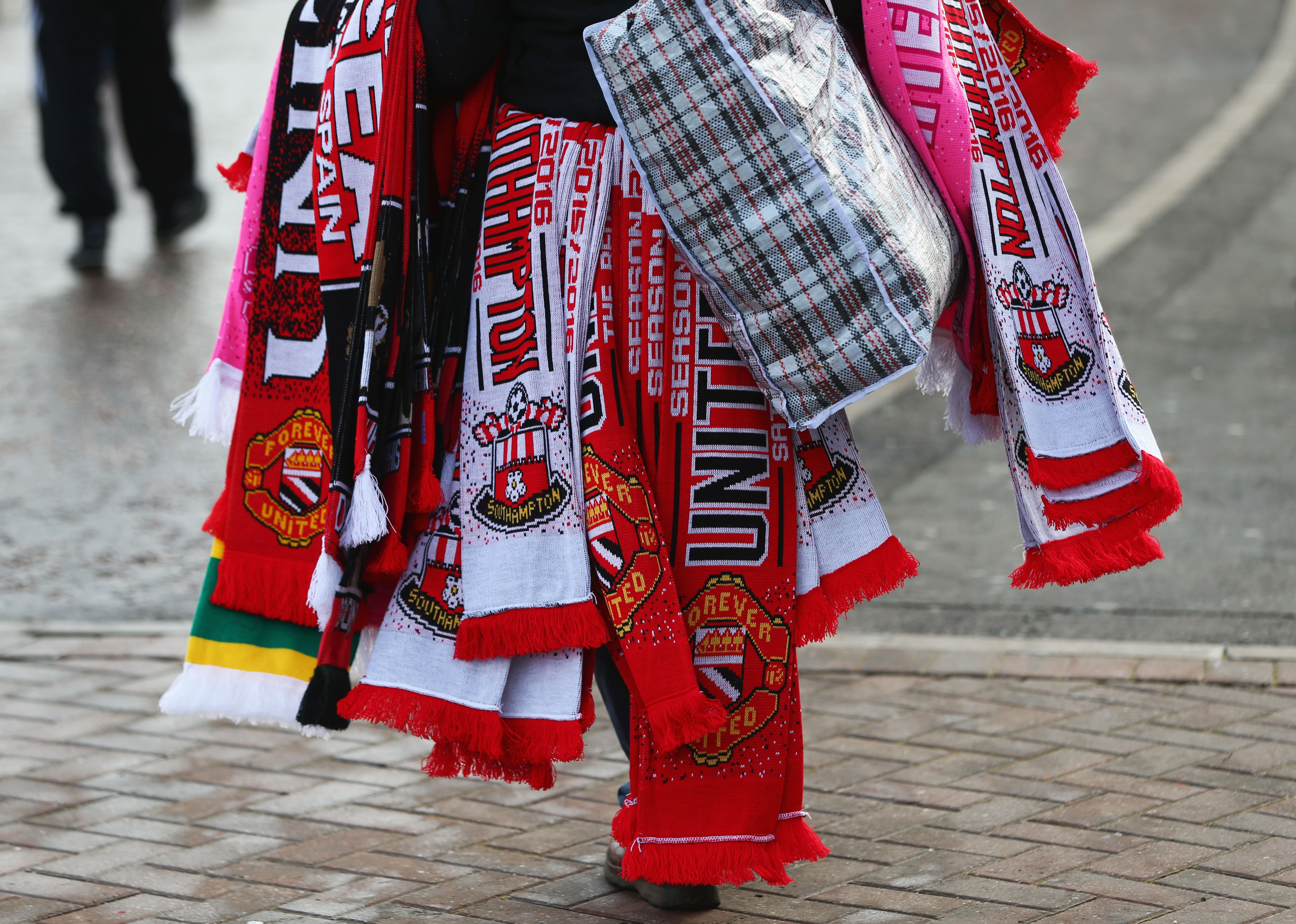 MANCHESTER, ENGLAND - JANUARY 23: Matchday scarves are on sale outside the stadium prior to the Barclays Premier League match between Manchester United and Southampton at Old Trafford on January 23, 2016 in Manchester, England. (Photo by Michael Steele/Getty Images)