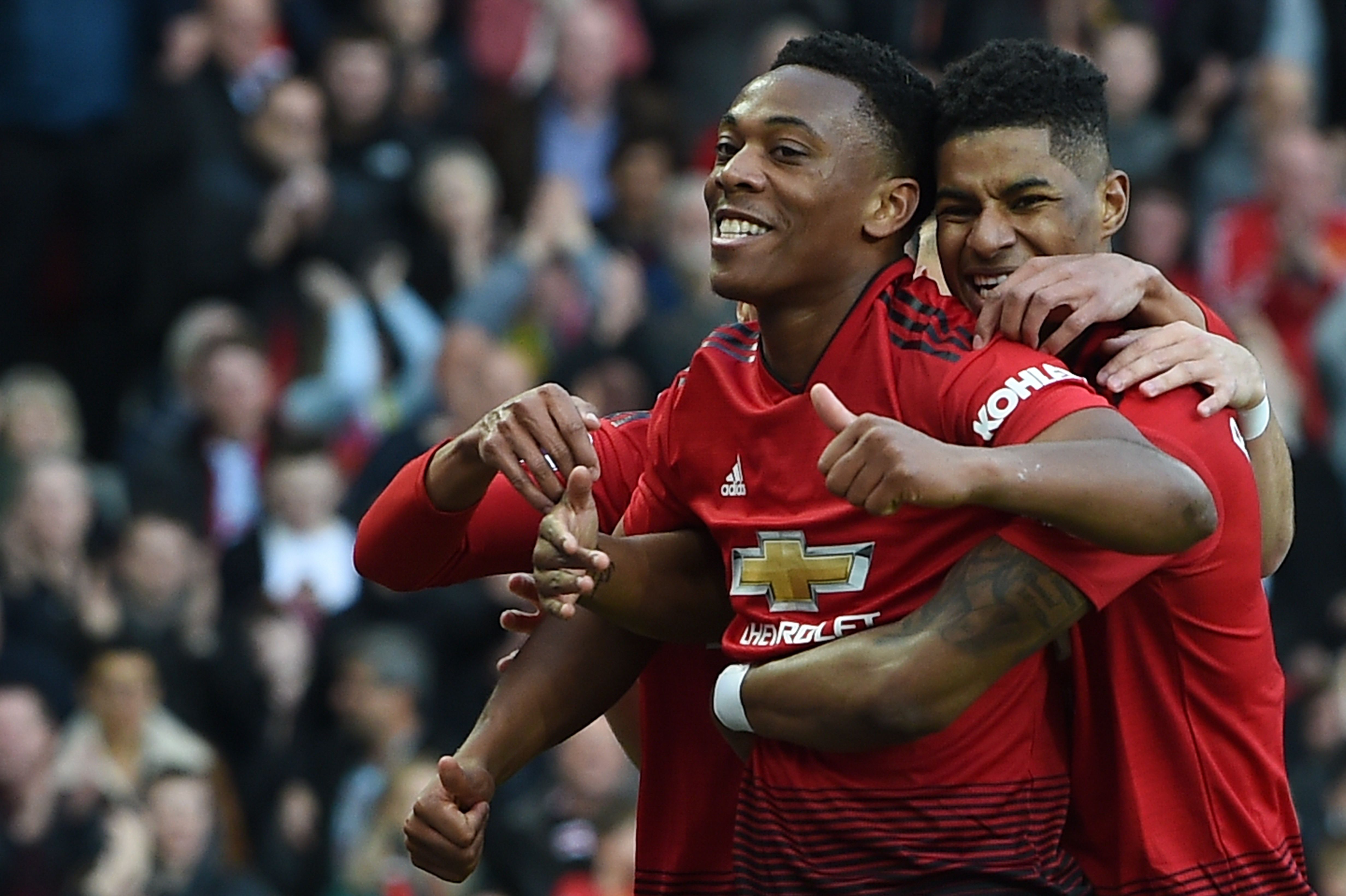 Manchester United's French forward Anthony Martial (C) celebrates scoring their second goal with Manchester United's English forward Marcus Rashford (R), and Manchester United's English midfielder Jesse Lingard (L) during the English Premier League football match between Manchester United and Watford at Old Trafford in Manchester, north west England, on March 30, 2019. (Photo by Paul ELLIS / AFP) / RESTRICTED TO EDITORIAL USE. No use with unauthorized audio, video, data, fixture lists, club/league logos or 'live' services. Online in-match use limited to 120 images. An additional 40 images may be used in extra time. No video emulation. Social media in-match use limited to 120 images. An additional 40 images may be used in extra time. No use in betting publications, games or single club/league/player publications. / (Photo credit should read PAUL ELLIS/AFP/Getty Images)