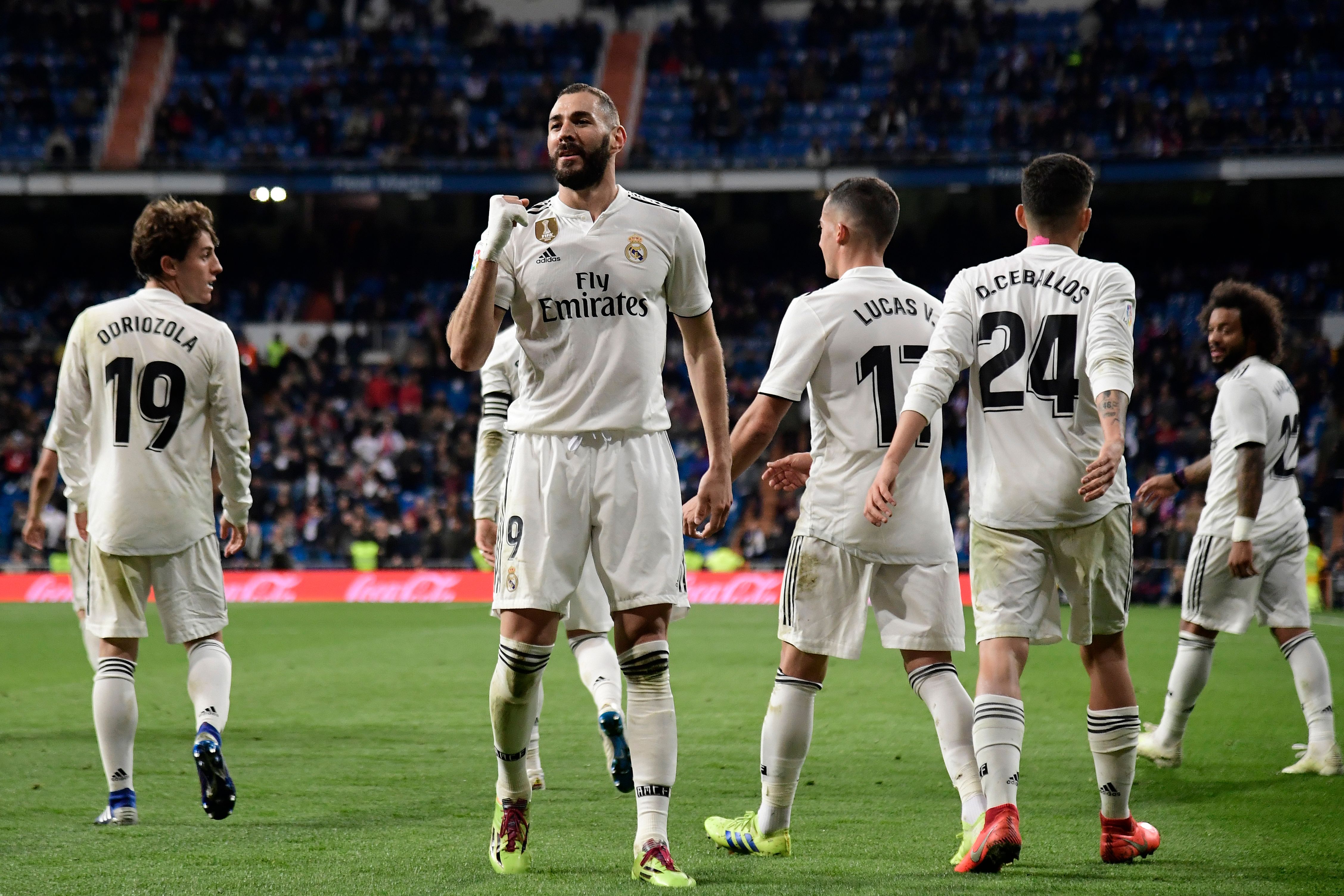 Real Madrid's French forward Karim Benzema (C) celebrates with teammates after scoring his team's third goal during the Spanish League football match between Real Madrid CF and SD Huesca at the Santiago Bernabeu stadium in Madrid on March 31, 2019. (Photo by JAVIER SORIANO / AFP) (Photo credit should read JAVIER SORIANO/AFP/Getty Images)