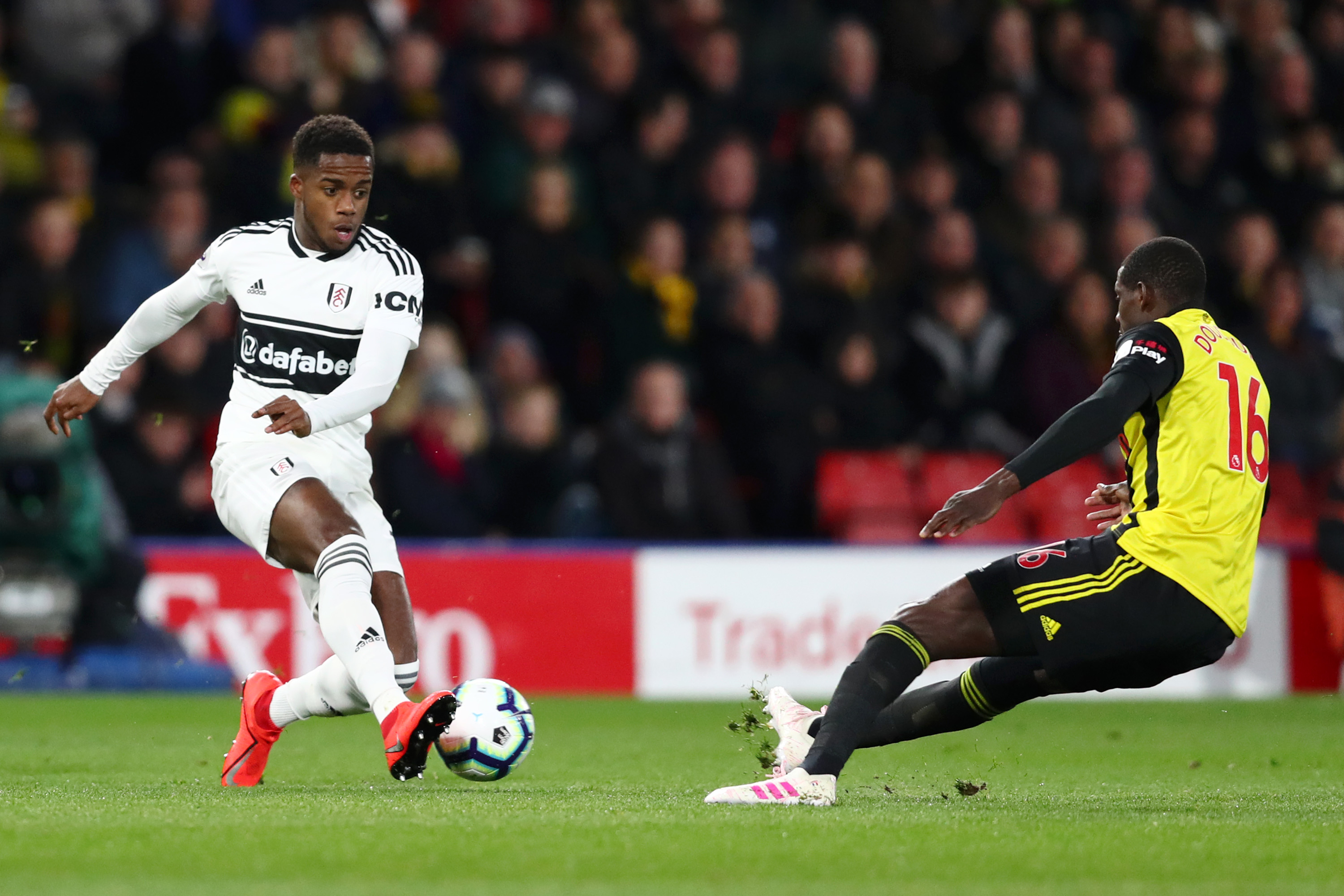 WATFORD, ENGLAND - APRIL 02: Ryan Sessegnon of Fulham is challenged by Abdoulaye Doucoure of Watford during the Premier League match between Watford FC and Fulham FC at Vicarage Road on April 02, 2019 in Watford, United Kingdom. (Photo by Dan Istitene/Getty Images)