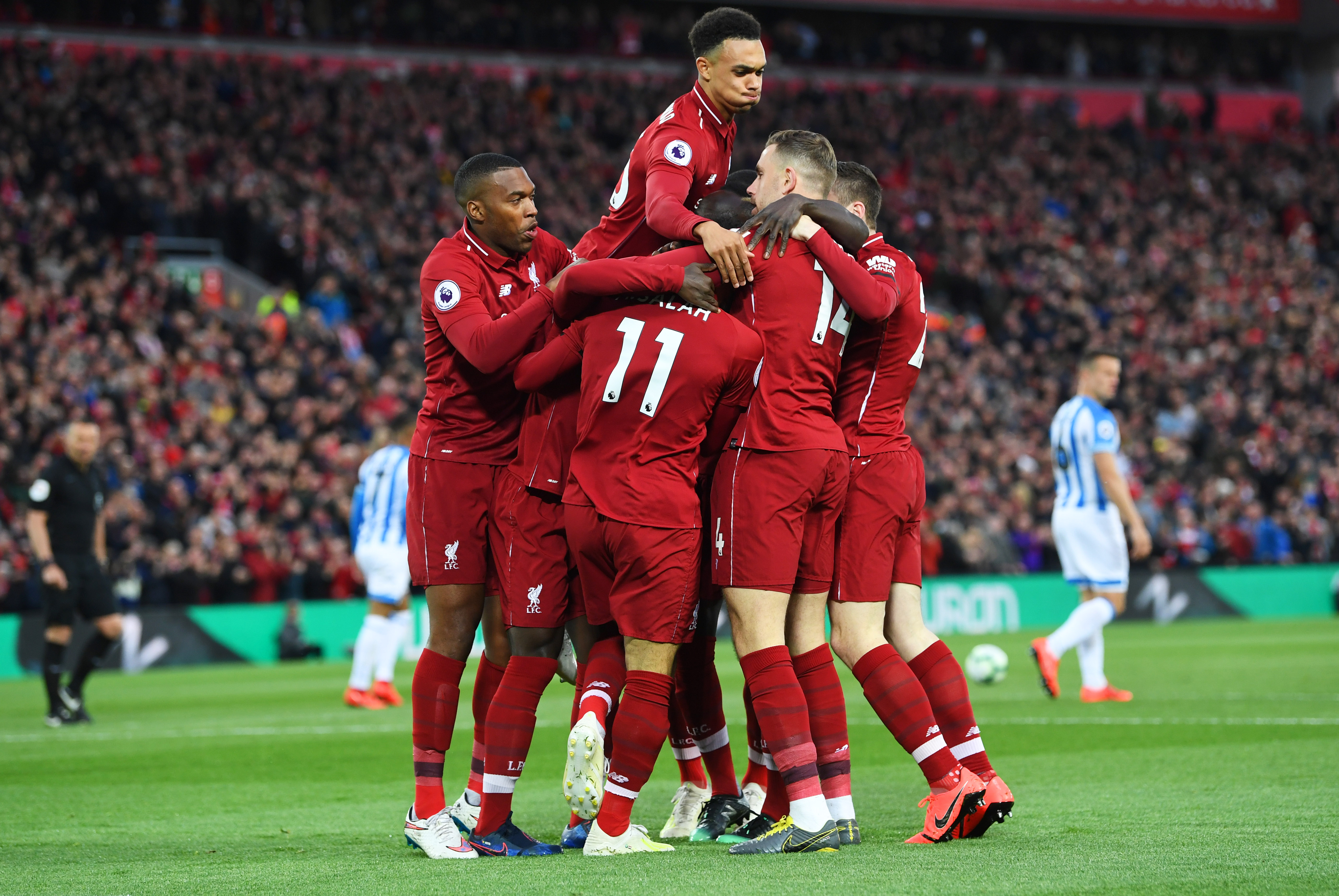 LIVERPOOL, ENGLAND - APRIL 26: Naby Keita of Liverpool (obscured) celebrates after scoring his team's first goal with team mates during the Premier League match between Liverpool FC and Huddersfield Town at Anfield on April 26, 2019 in Liverpool, United Kingdom. (Photo by Michael Regan/Getty Images)
