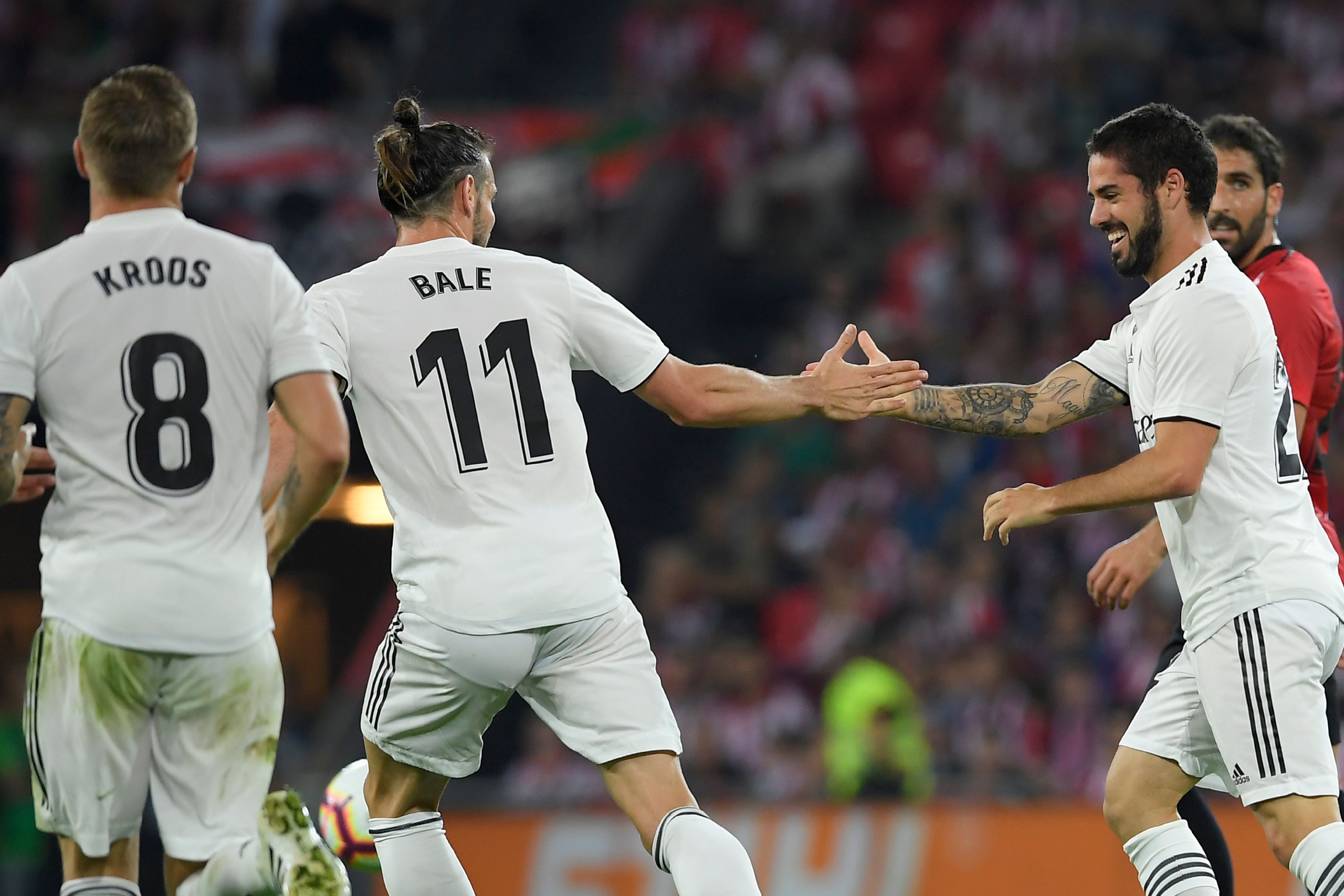 Real Madrid's Spanish midfielder Isco (R) celebrates with Real Madrid's Welsh forward Gareth Bale after scoring during the Spanish league football match between Athletic Club Bilbao and Real Madrid CF at the San Mames stadium in Bilbao on September 15, 2018. (Photo by LLUIS GENE / AFP) (Photo credit should read LLUIS GENE/AFP/Getty Images)