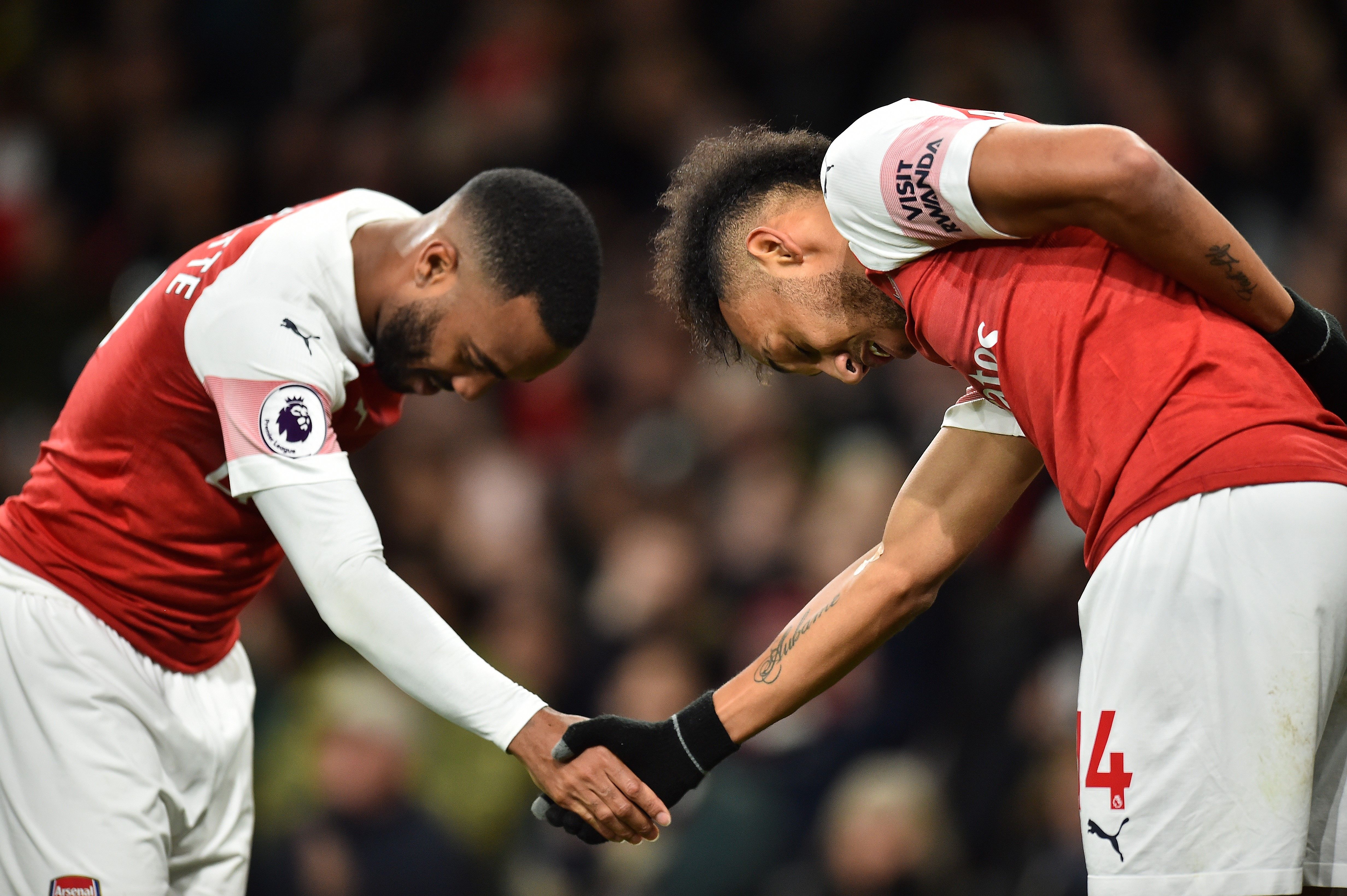 TOPSHOT - Arsenal's French striker Alexandre Lacazette celebrates scoring his team's second goal with Arsenal's Gabonese striker Pierre-Emerick Aubameyang during the English Premier League football match between Arsenal and Newcastle United at the Emirates Stadium in London on April 1, 2019. (Photo by Glyn KIRK / AFP) / RESTRICTED TO EDITORIAL USE. No use with unauthorized audio, video, data, fixture lists, club/league logos or 'live' services. Online in-match use limited to 120 images. An additional 40 images may be used in extra time. No video emulation. Social media in-match use limited to 120 images. An additional 40 images may be used in extra time. No use in betting publications, games or single club/league/player publications. /         (Photo credit should read GLYN KIRK/AFP/Getty Images)