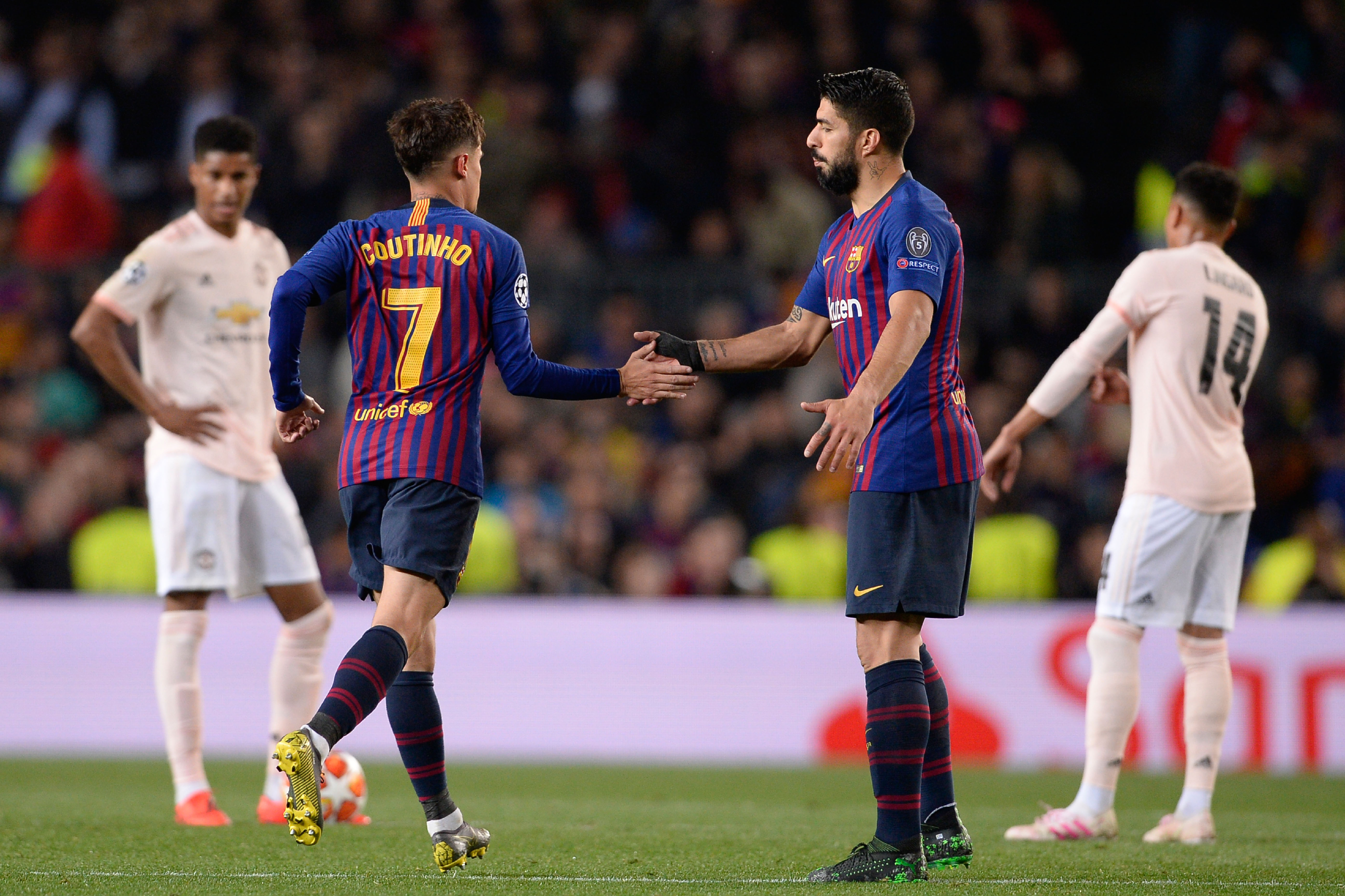 Barcelona's Brazilian midfielder Philippe Coutinho (L) celebrates with Barcelona's Uruguayan forward Luis Suarez after scoring during the UEFA Champions League quarter-final second leg football match between Barcelona and Manchester United at the Camp Nou stadium in Barcelona on April 16, 2019. (Photo by PAU BARRENA / AFP) (Photo credit should read PAU BARRENA/AFP/Getty Images)