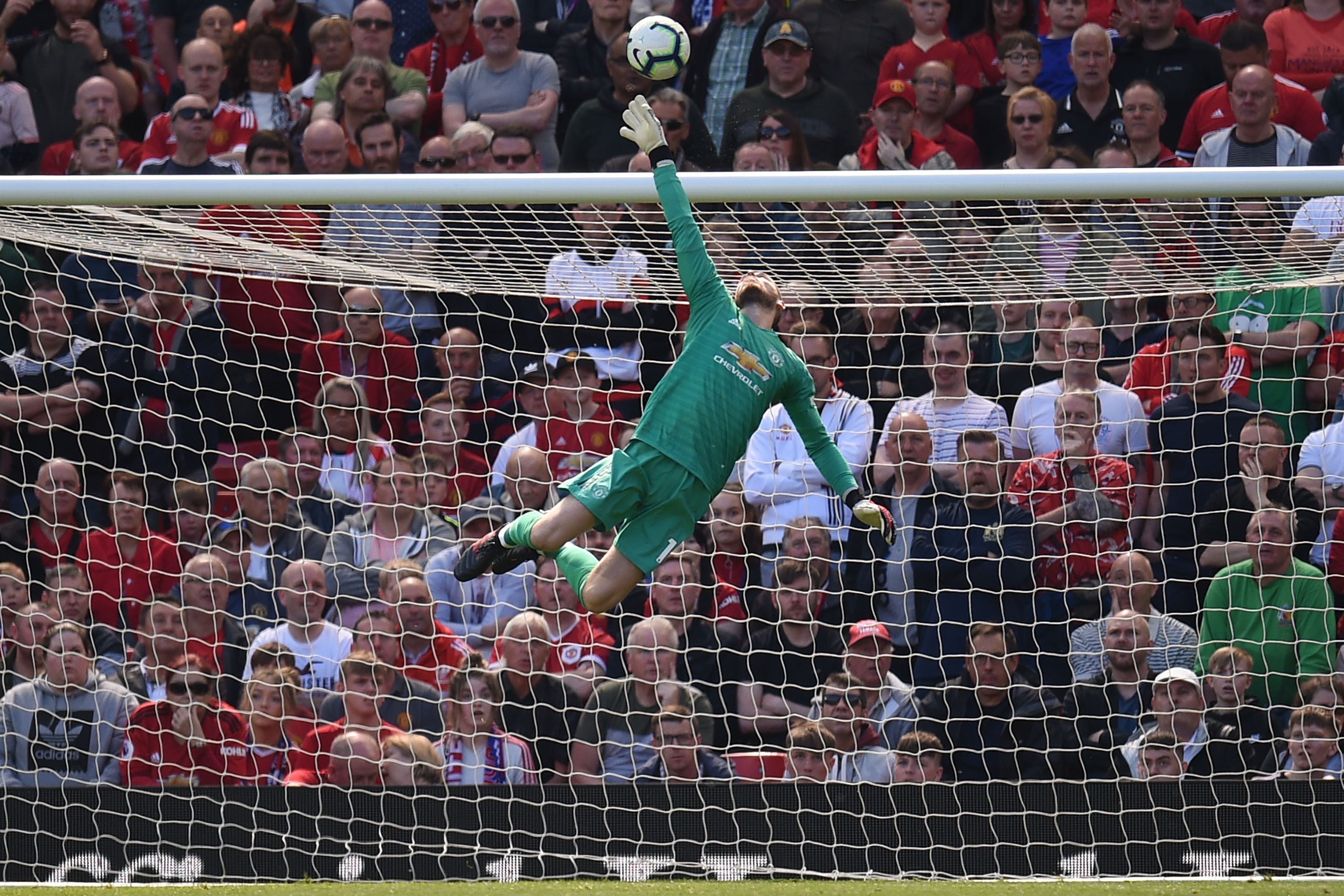 TOPSHOT - Manchester United's Spanish goalkeeper David de Gea makes a save during the English Premier League football match between Manchester United and Cardiff City at Old Trafford in Manchester, north west England, on May 12, 2019. (Photo by Oli SCARFF / AFP) / RESTRICTED TO EDITORIAL USE. No use with unauthorized audio, video, data, fixture lists, club/league logos or 'live' services. Online in-match use limited to 120 images. An additional 40 images may be used in extra time. No video emulation. Social media in-match use limited to 120 images. An additional 40 images may be used in extra time. No use in betting publications, games or single club/league/player publications. / (Photo credit should read OLI SCARFF/AFP/Getty Images)