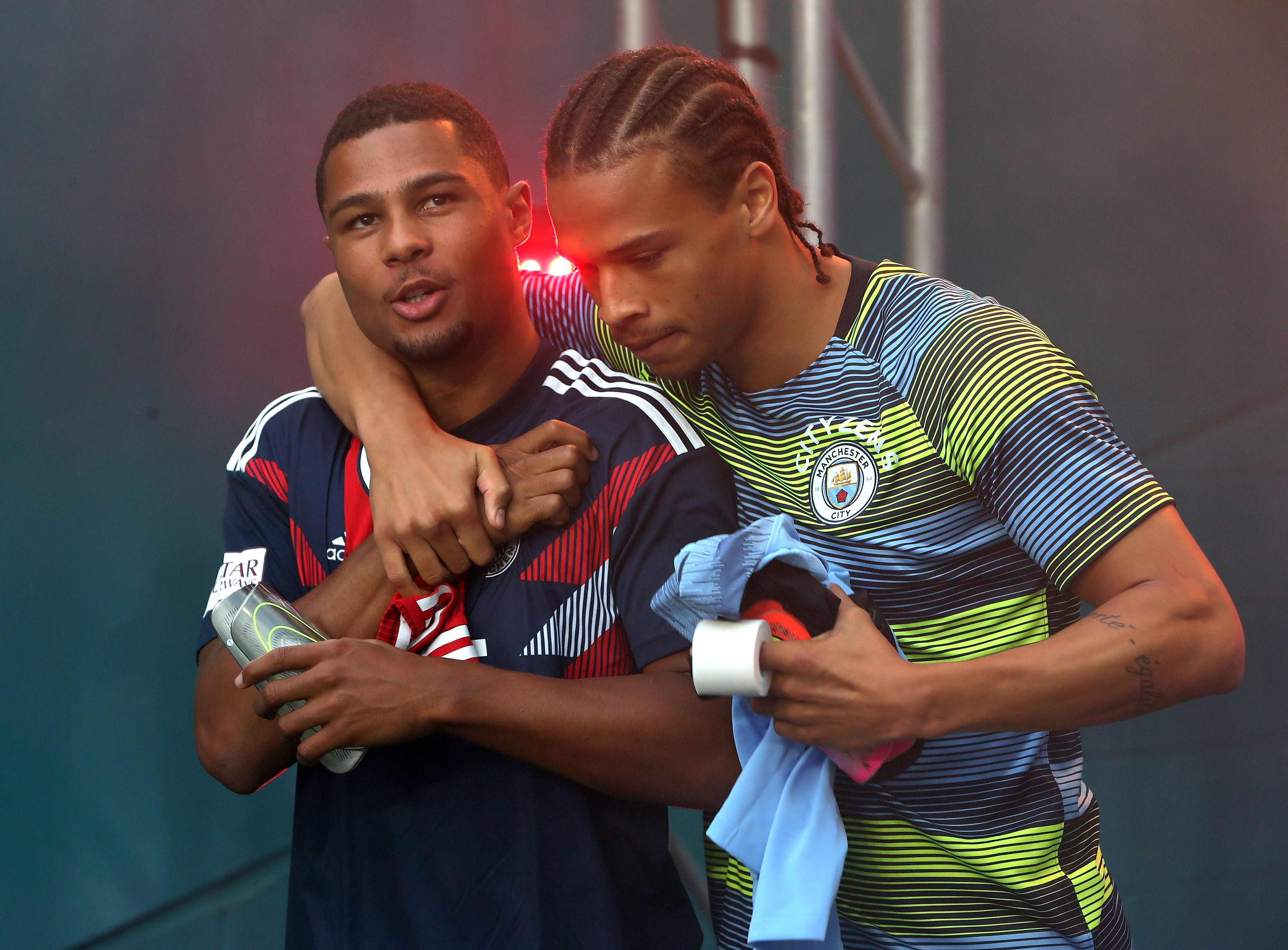 Former Arsenal star Serge Gnarby (L) wants International teammate Leroy Sane (R) to join him at Bayern. (Photo courtesy: AFP/Getty)