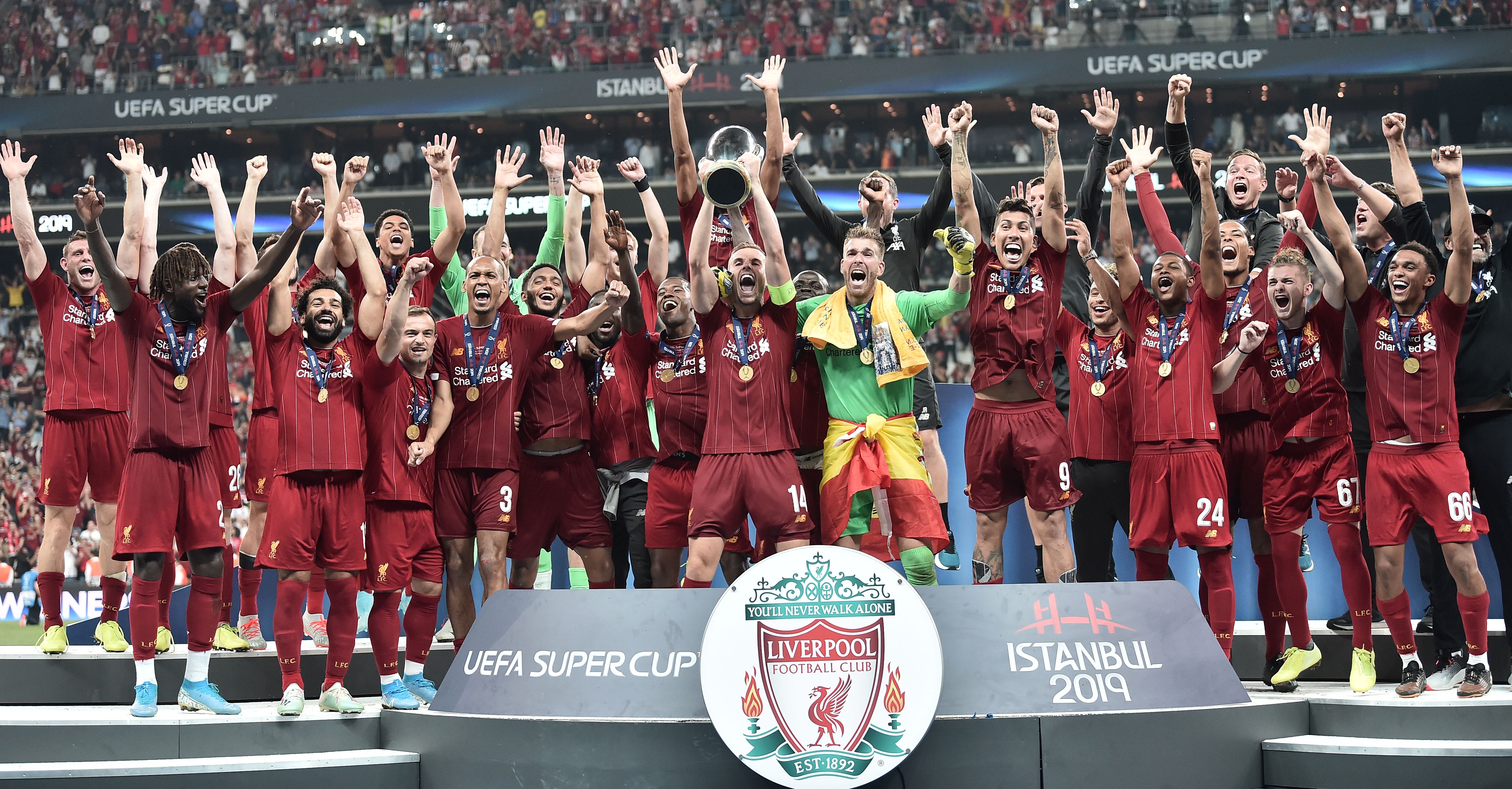 Liverpool team poses with the trophy after winning the UEFA Super Cup 2019 football match between FC Liverpool and FC Chelsea at Besiktas Park Stadium in Istanbul on August 14, 2019. (Photo by OZAN KOSE / AFP) (Photo credit should read OZAN KOSE/AFP/Getty Images)