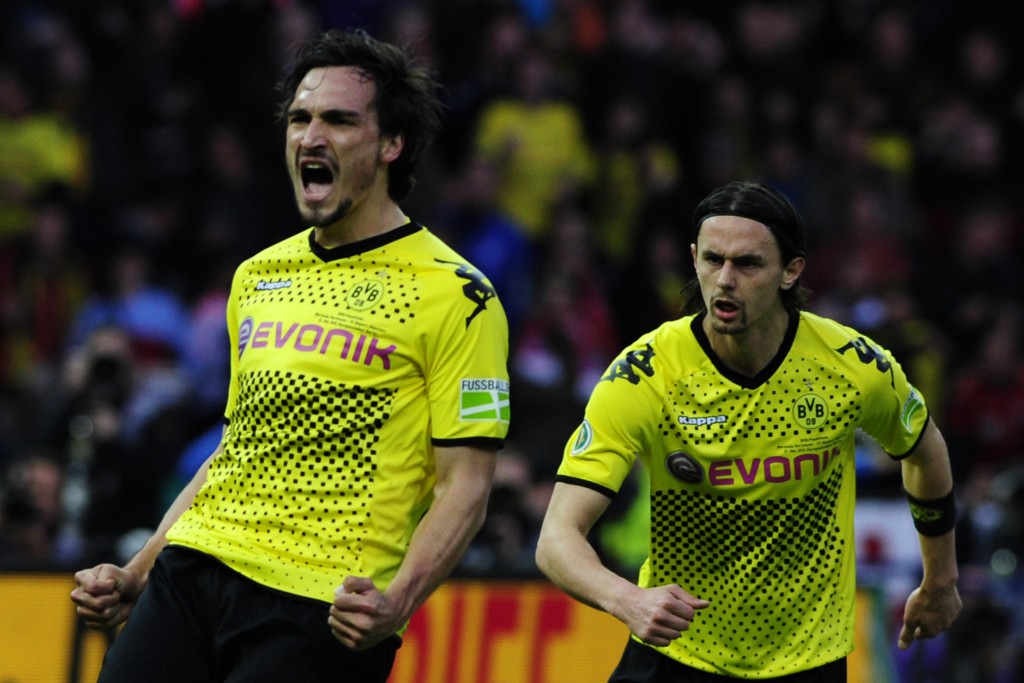 Dortmund's defender Mats Hummels (L) celebrates with his teammate Dortmund's US defender Neven Subotic after scoring the 2-1 during the German cup " DFB Pokal " final football match Borussia Dortmund vs Bayern Munich at the Olympiastadion in Berlin on May 12, 2012. AFP PHOTO / JOHN MACDOUGALL RESTRICTIONS / EMBARGO - DFB LIMITS THE USE OF IMAGES ON THE INTERNET TO 15 PICTURES (NO VIDEO-LIKE SEQUENCES) DURING THE MATCH AND PROHIBITS MOBILE (MMS) USE DURING AND FOR FURTHER TWO HOURS AFTER THE MATCH. FOR MORE INFORMATION CONTACT DFB. (Photo credit should read JOHN MACDOUGALL/AFP/GettyImages)