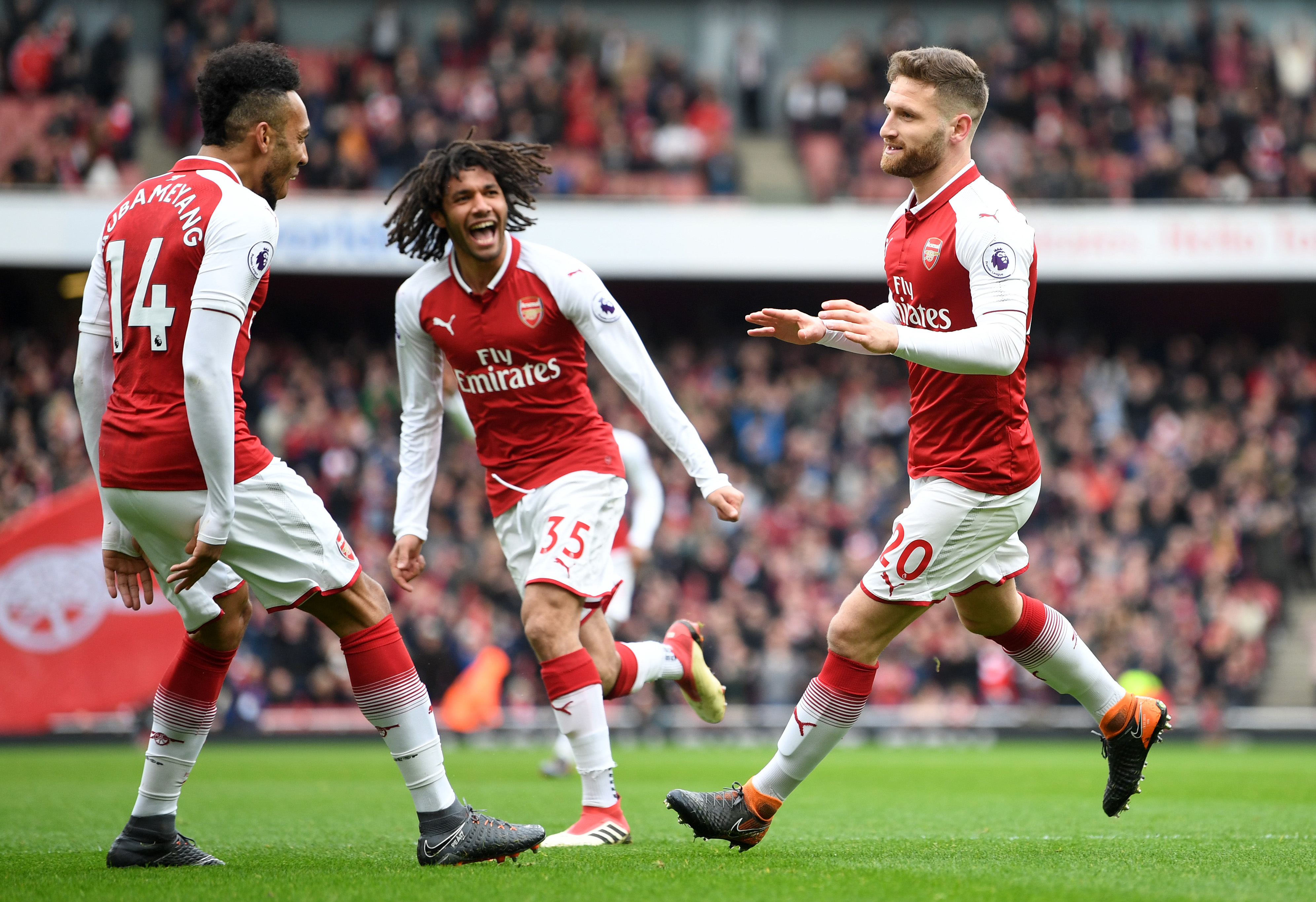 LONDON, ENGLAND - MARCH 11: Shkodran Mustafi of Arsenal celebrates coring the first goal with Pierre-Emerick Aubameyang of Arsenal and Mohamed Elneny of Arsenal during the Premier League match between Arsenal and Watford at Emirates Stadium on March 11, 2018 in London, England. (Photo by Michael Regan/Getty Images)