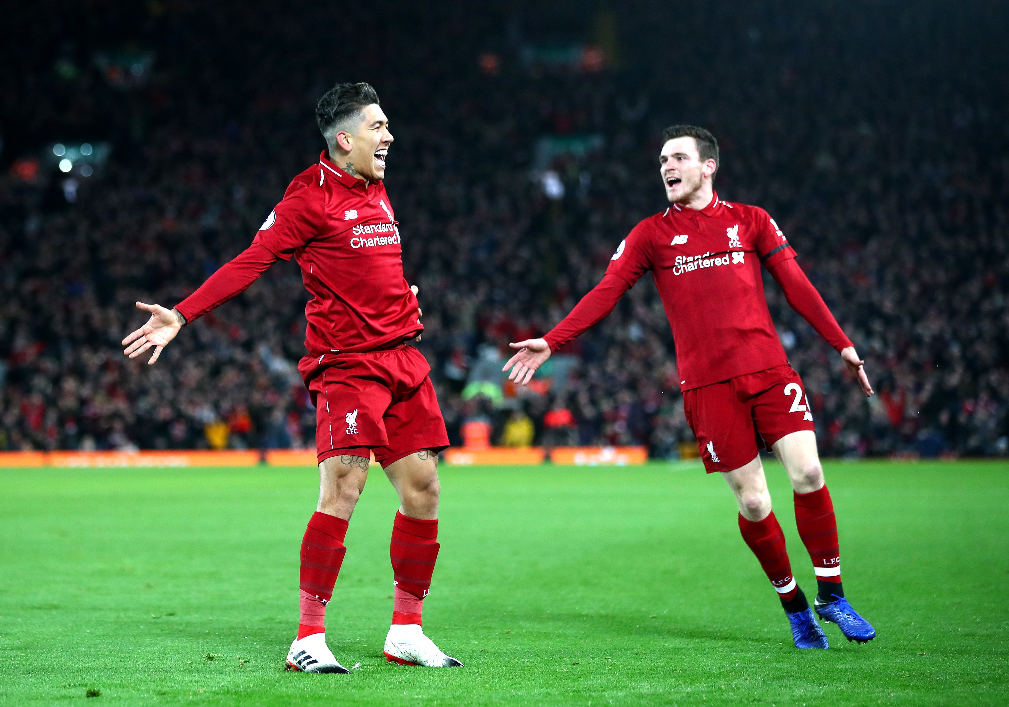 LIVERPOOL, ENGLAND - DECEMBER 29: Roberto Firmino of Liverpool celebrates with Andy Robertson after scoring his sides second goal during the Premier League match between Liverpool FC and Arsenal FC at Anfield on December 29, 2018 in Liverpool, United Kingdom. (Photo by Clive Brunskill/Getty Images)