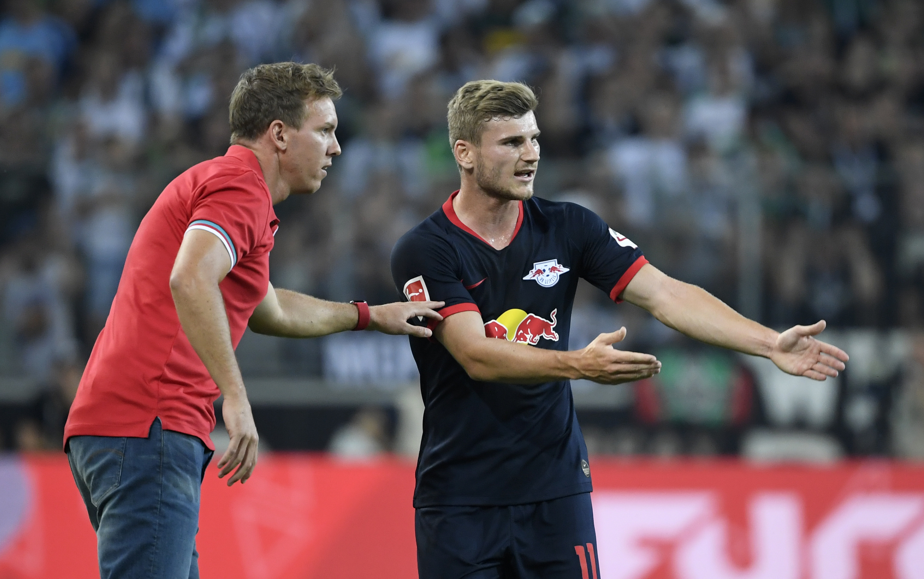 Leipzig's German headcoach Julian Nagelsmann and Leipzig's German forward Timo Werner (R) talk during the German first division Bundesliga football match Borussia Moenchengladbach v RB Leipzig in Moenchengladbach, western Germany on August 30, 2019. (Photo by Ina FASSBENDER / AFP) / RESTRICTIONS: DFL REGULATIONS PROHIBIT ANY USE OF PHOTOGRAPHS AS IMAGE SEQUENCES AND/OR QUASI-VIDEO (Photo credit should read INA FASSBENDER/AFP/Getty Images)
