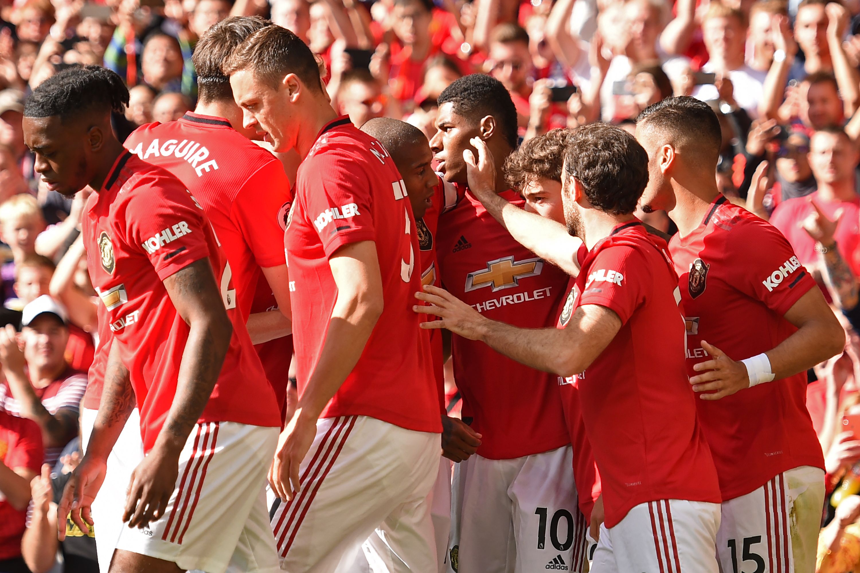Manchester United's English striker Marcus Rashford (C) celebrates with teammates after scoring the opening goal of the English Premier League football match between Manchester United and Leicester City at Old Trafford in Manchester, north west England, on September 14, 2019. (Photo by Oli SCARFF / AFP) / RESTRICTED TO EDITORIAL USE. No use with unauthorized audio, video, data, fixture lists, club/league logos or 'live' services. Online in-match use limited to 120 images. An additional 40 images may be used in extra time. No video emulation. Social media in-match use limited to 120 images. An additional 40 images may be used in extra time. No use in betting publications, games or single club/league/player publications. / (Photo credit should read OLI SCARFF/AFP/Getty Images)