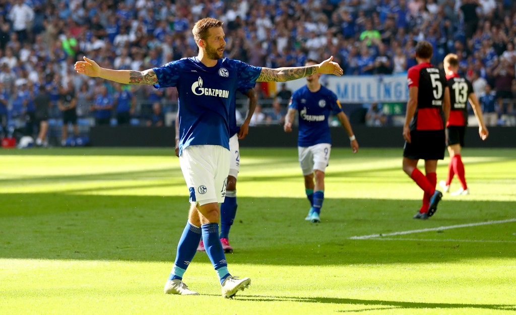GELSENKIRCHEN, GERMANY - AUGUST 31: Guido Burgstaller of Schalke and Daniel Caligiuri of Schalke celebrate after the first goal during the Bundesliga match between FC Schalke 04 and Hertha BSC at Veltins-Arena on August 31, 2019 in Gelsenkirchen, Germany. (Photo by Lars Baron/Bongarts/Getty Images)