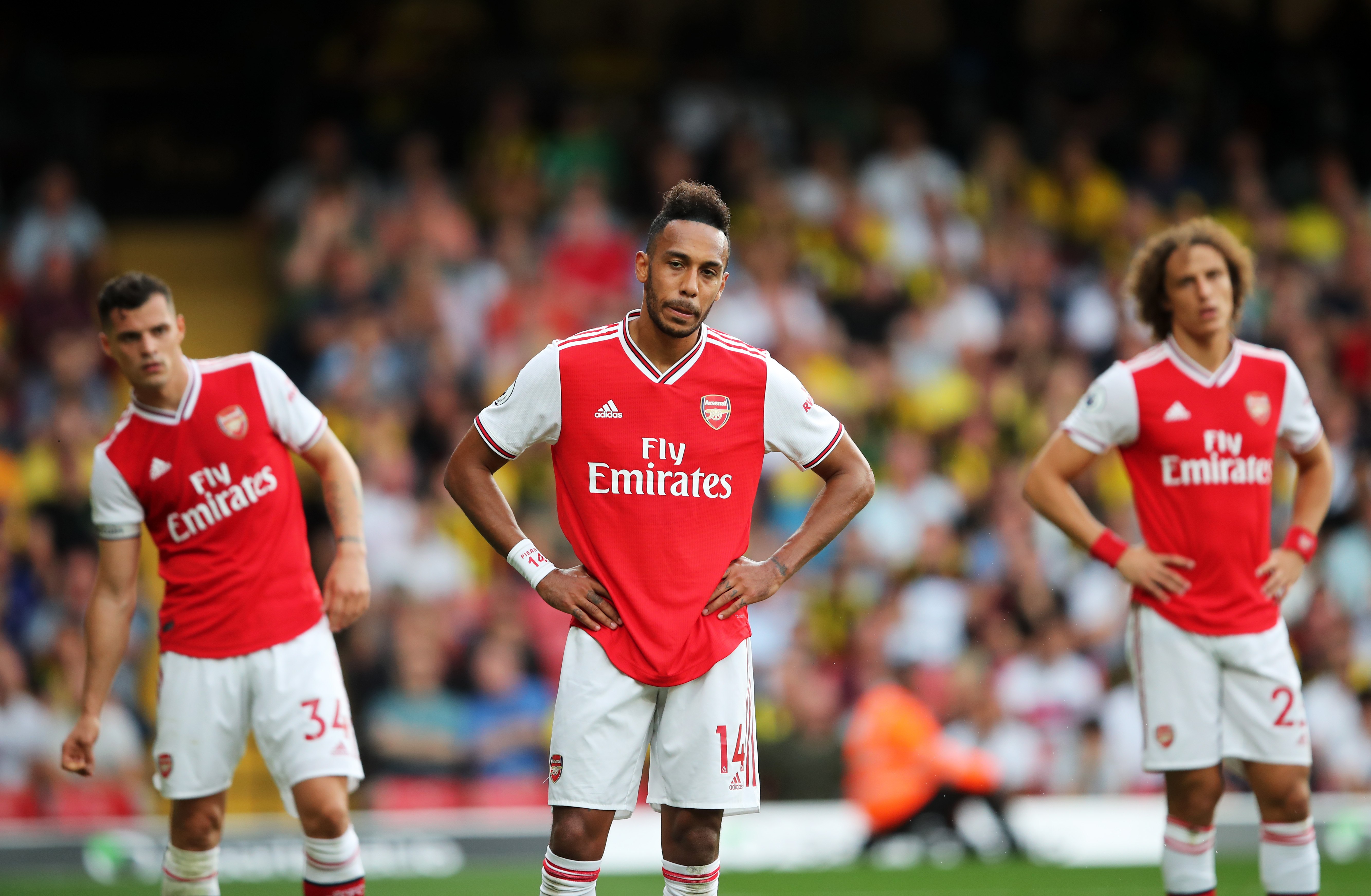 WATFORD, ENGLAND - SEPTEMBER 15: Pierre-Emerick Aubameyang of Arsenal (14) and team mates Granit Xhaka and David Luiz react during the Premier League match between Watford FC and Arsenal FC at Vicarage Road on September 15, 2019 in Watford, United Kingdom. (Photo by Marc Atkins/Getty Images)