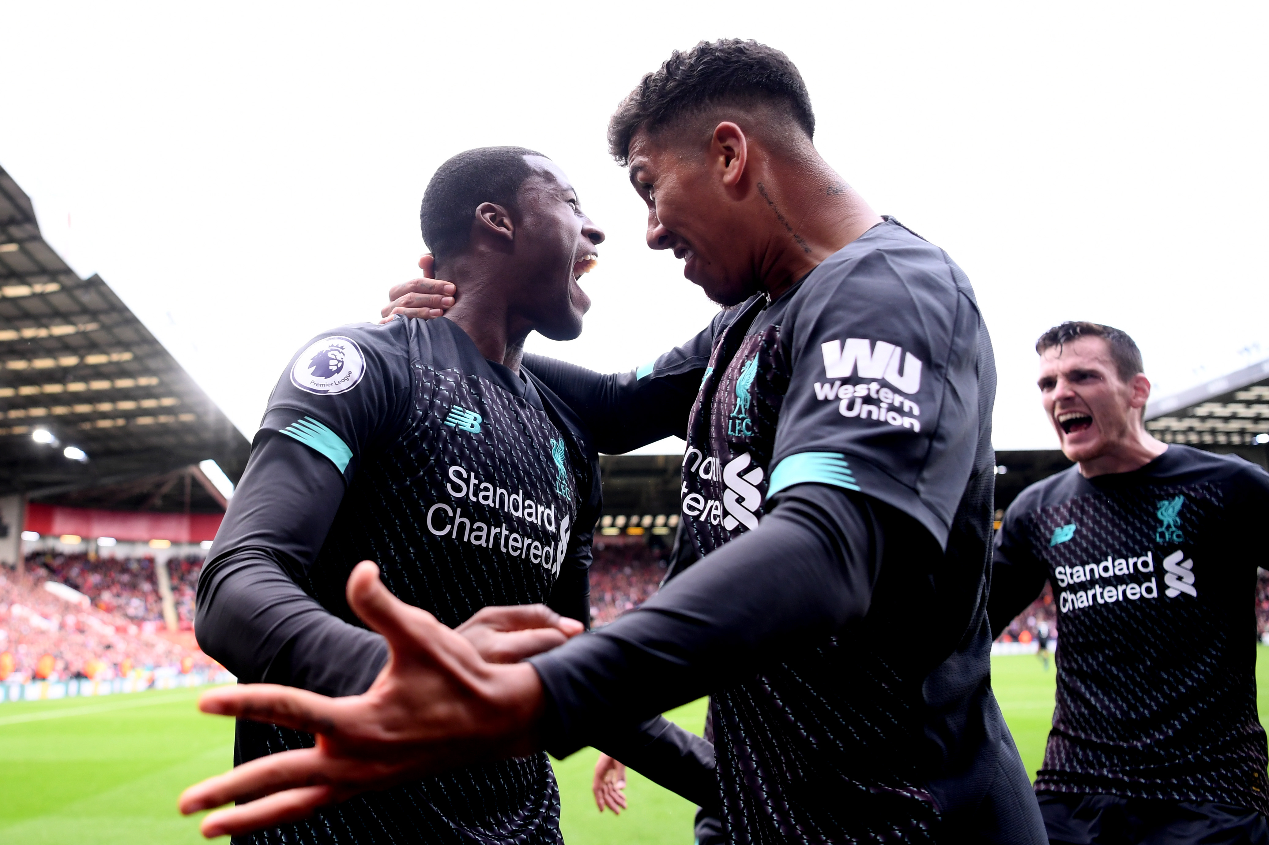 SHEFFIELD, ENGLAND - SEPTEMBER 28: Georginio Wijnaldum of Liverpool celebrates with teammate Roberto Firmino after scoring his team's first goal during the Premier League match between Sheffield United and Liverpool FC at Bramall Lane on September 28, 2019 in Sheffield, United Kingdom. (Photo by Laurence Griffiths/Getty Images)