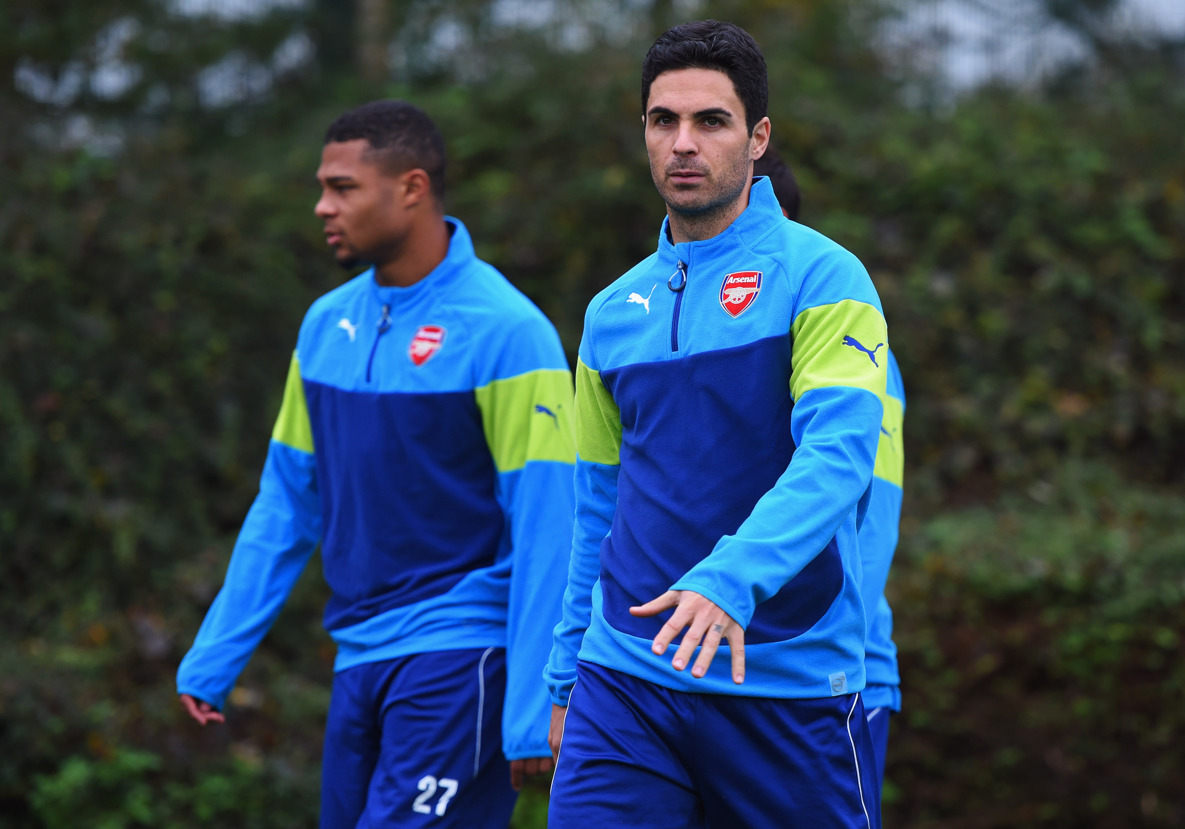 ST ALBANS, ENGLAND - NOVEMBER 03: (L-R) Serge Gnabry and Mikel Arteta look on during an Arsenal training session ahead of the UEFA Champions League match against RSC Anderlecht at London Colney on November 3, 2014 in St Albans, England. (Photo by Michael Regan/Getty Images)
