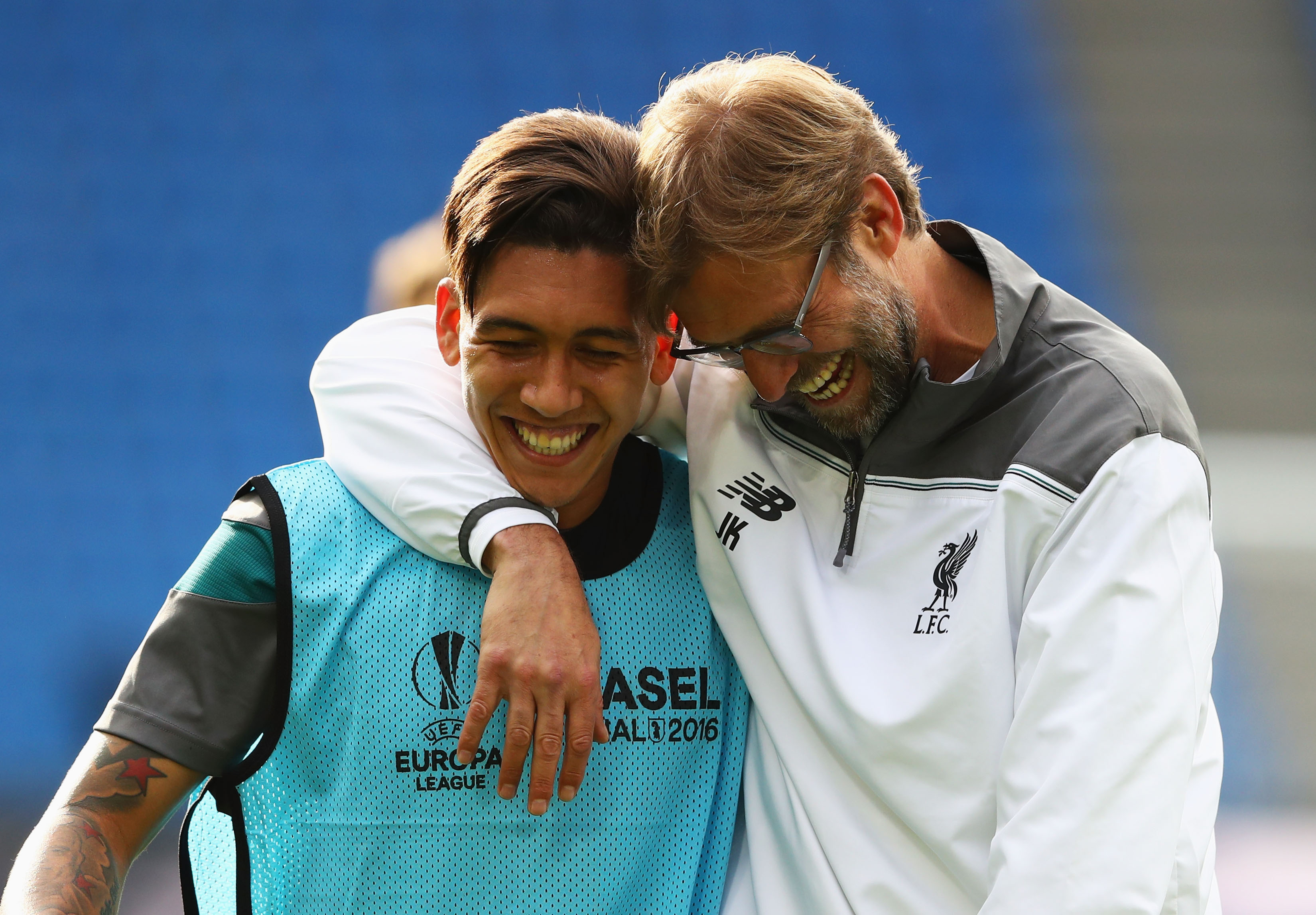 BASEL, SWITZERLAND - MAY 17: Roberto Firmino of Liverpool laughs with manager Jurgen Klopp during a Liverpool training session on the eve of the UEFA Europa League Final against Sevilla at St. Jakob-Park on May 17, 2016 in Basel, Switzerland. (Photo by Michael Steele/Getty Images)