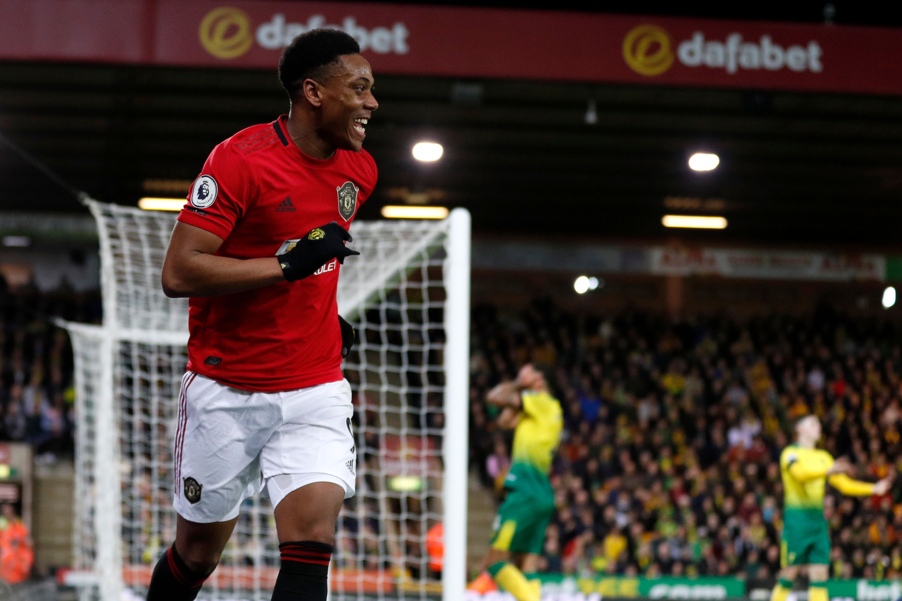 Manchester United's French striker Anthony Martial celebrates after scoring their third goal during the English Premier League football match between Norwich City and Manchester United at Carrow Road in Norwich, eastern England on October 27, 2019. (Photo by Adrian DENNIS / AFP) / RESTRICTED TO EDITORIAL USE. No use with unauthorized audio, video, data, fixture lists, club/league logos or 'live' services. Online in-match use limited to 120 images. An additional 40 images may be used in extra time. No video emulation. Social media in-match use limited to 120 images. An additional 40 images may be used in extra time. No use in betting publications, games or single club/league/player publications. /  (Photo by ADRIAN DENNIS/AFP via Getty Images)