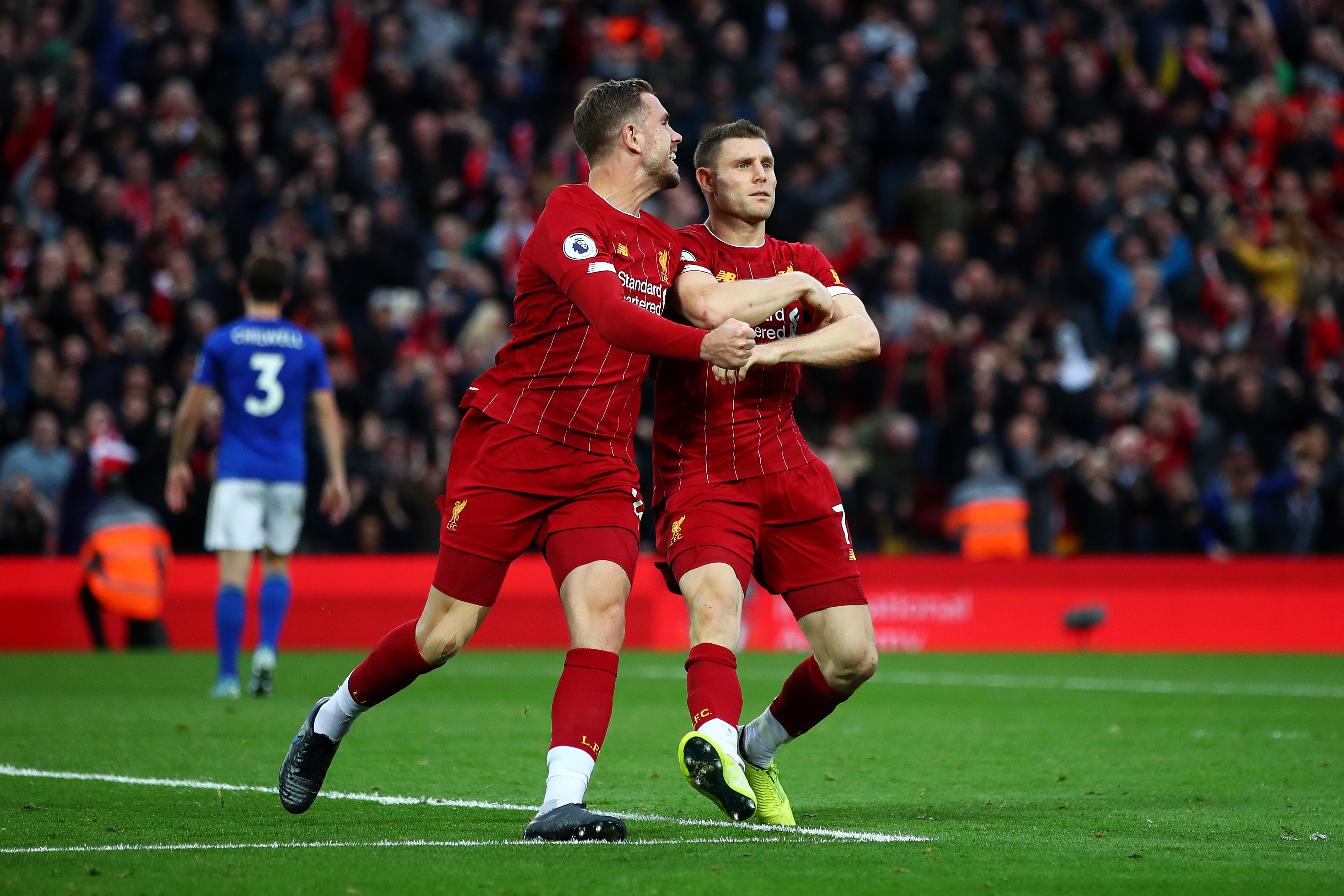 LIVERPOOL, ENGLAND - OCTOBER 05: James Milner of Liverpool celebrates with Jordan Henderson of Liverpool and Divock Origi of Liverpool after he scores his sides second goal from the penalty spot during the Premier League match between Liverpool FC and Leicester City at Anfield on October 05, 2019 in Liverpool, United Kingdom. (Photo by Clive Brunskill/Getty Images)