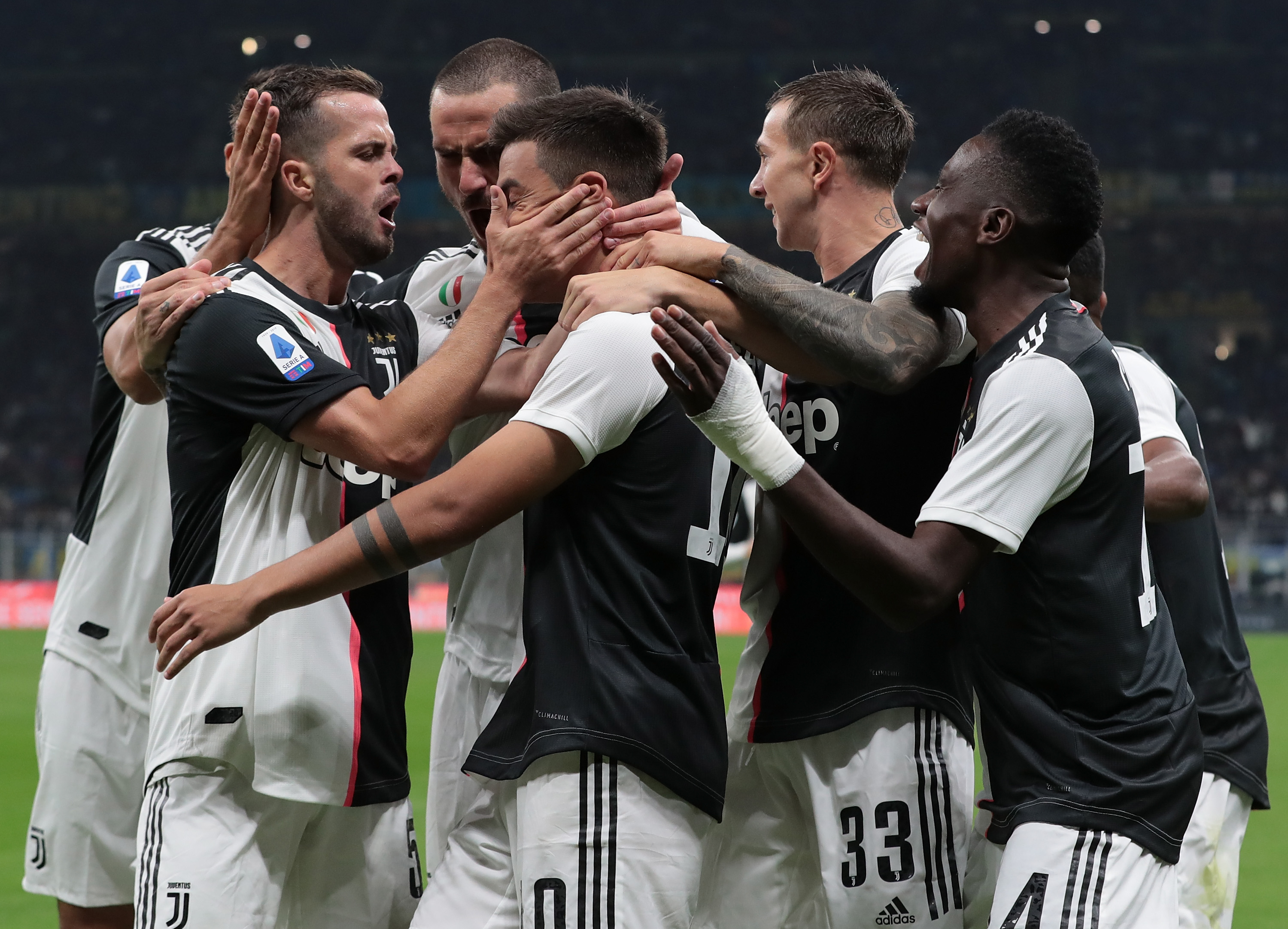 MILAN, ITALY - OCTOBER 06: Paulo Dybala of Juventus celebrates with his team-mates after scoring the opening goal during the Serie A match between FC Internazionale and Juventus at Stadio Giuseppe Meazza on October 6, 2019 in Milan, Italy. (Photo by Emilio Andreoli/Getty Images)
