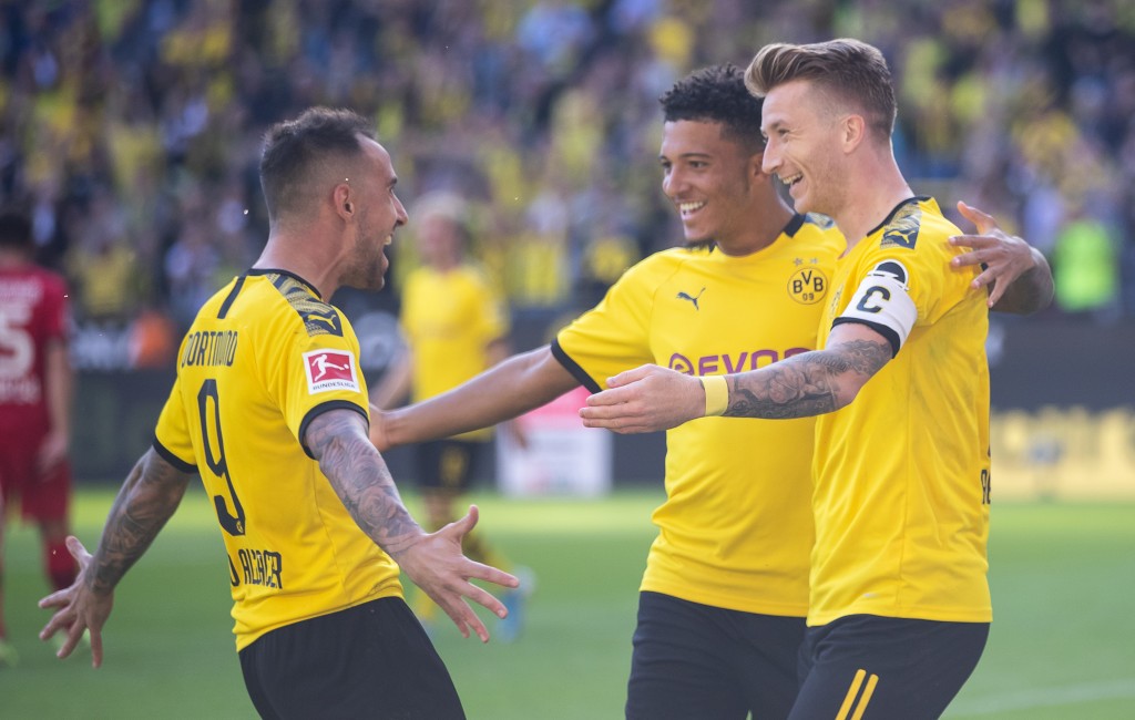 DORTMUND, GERMANY - SEPTEMBER 14: Marco Reus of Dortmund ceelebrates with Jadon Sancho of Dortmund and Paco Alcacer of Dortmund during the Bundesliga match between Borussia Dortmund and Bayer 04 Leverkusen at Signal Iduna Park on September 14, 2019 in Dortmund, Germany. (Photo by Lars Baron/Bongarts/Getty Images)