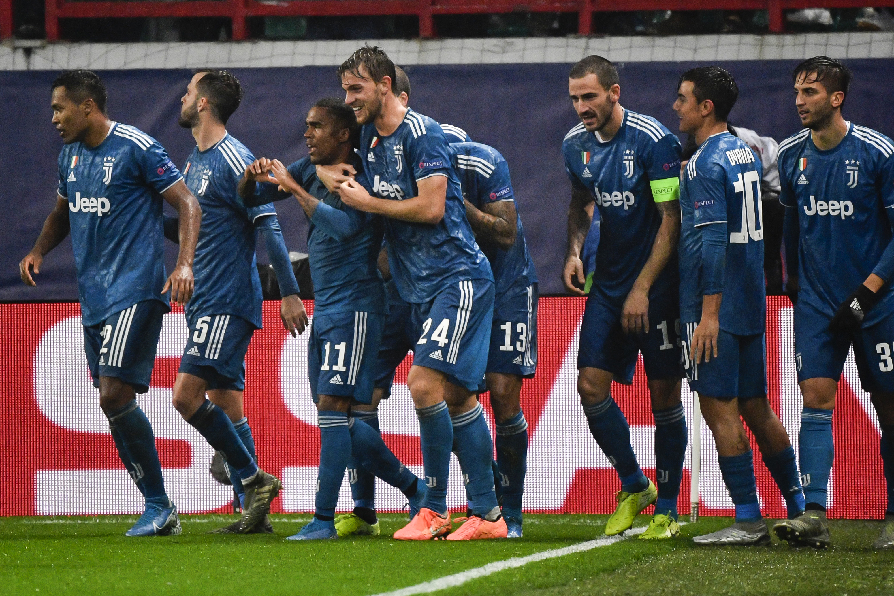 Juventus' Brazilian forward Douglas Costa celebrates with teammates after scoring a goal during the UEFA Champions League group D football match between FC Lokomotiv Moscow and Juventus at Moscow's RZD Arena stadium on November 6, 2019. (Photo by Alexander NEMENOV / AFP) (Photo by ALEXANDER NEMENOV/AFP via Getty Images)