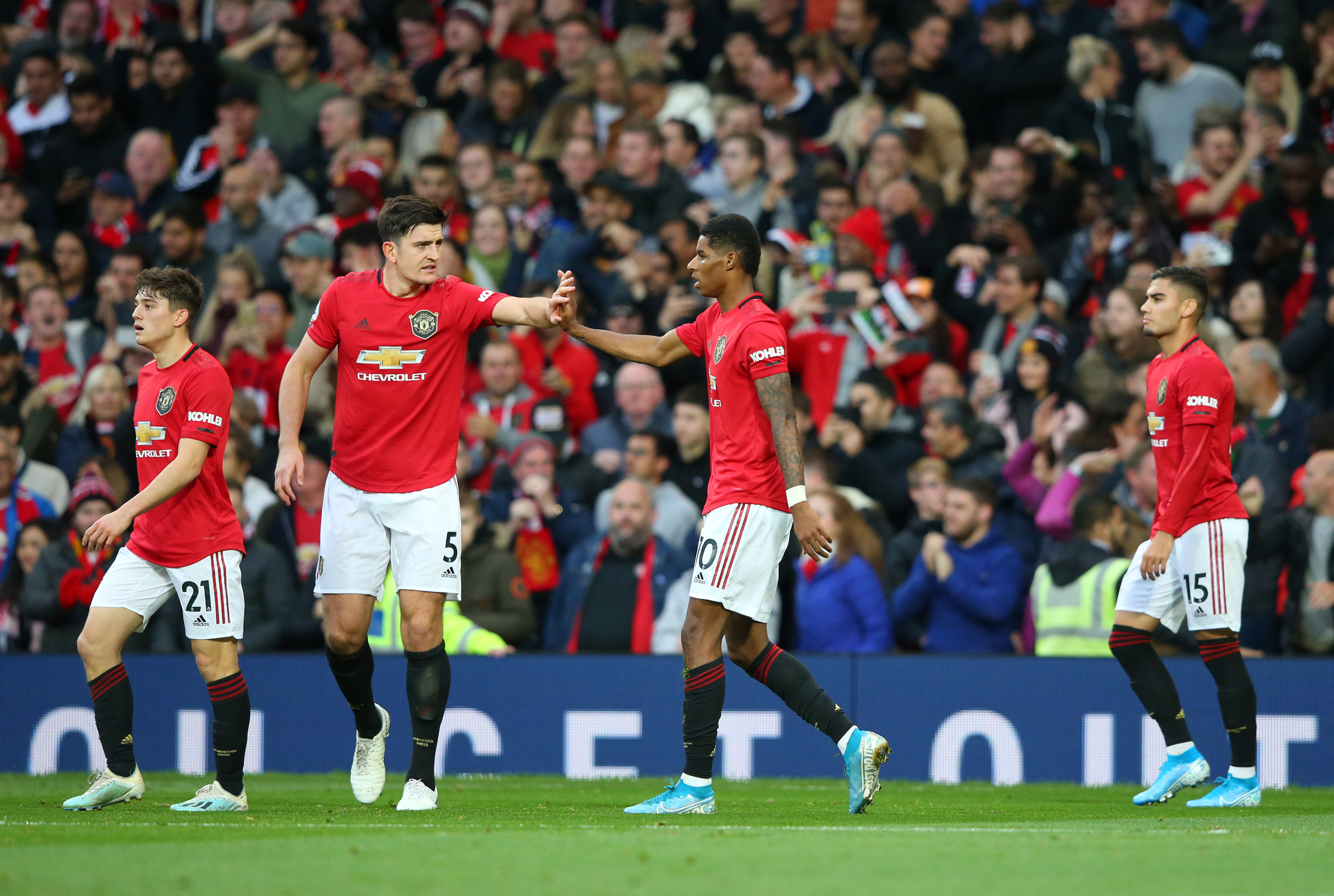 MANCHESTER, ENGLAND - OCTOBER 20: Marcus Rashford of Manchester United(2R) celebrates after scoring his sides first goal with Harry Maguire of Manchester United during the Premier League match between Manchester United and Liverpool FC at Old Trafford on October 20, 2019 in Manchester, United Kingdom. (Photo by Alex Livesey/Getty Images)