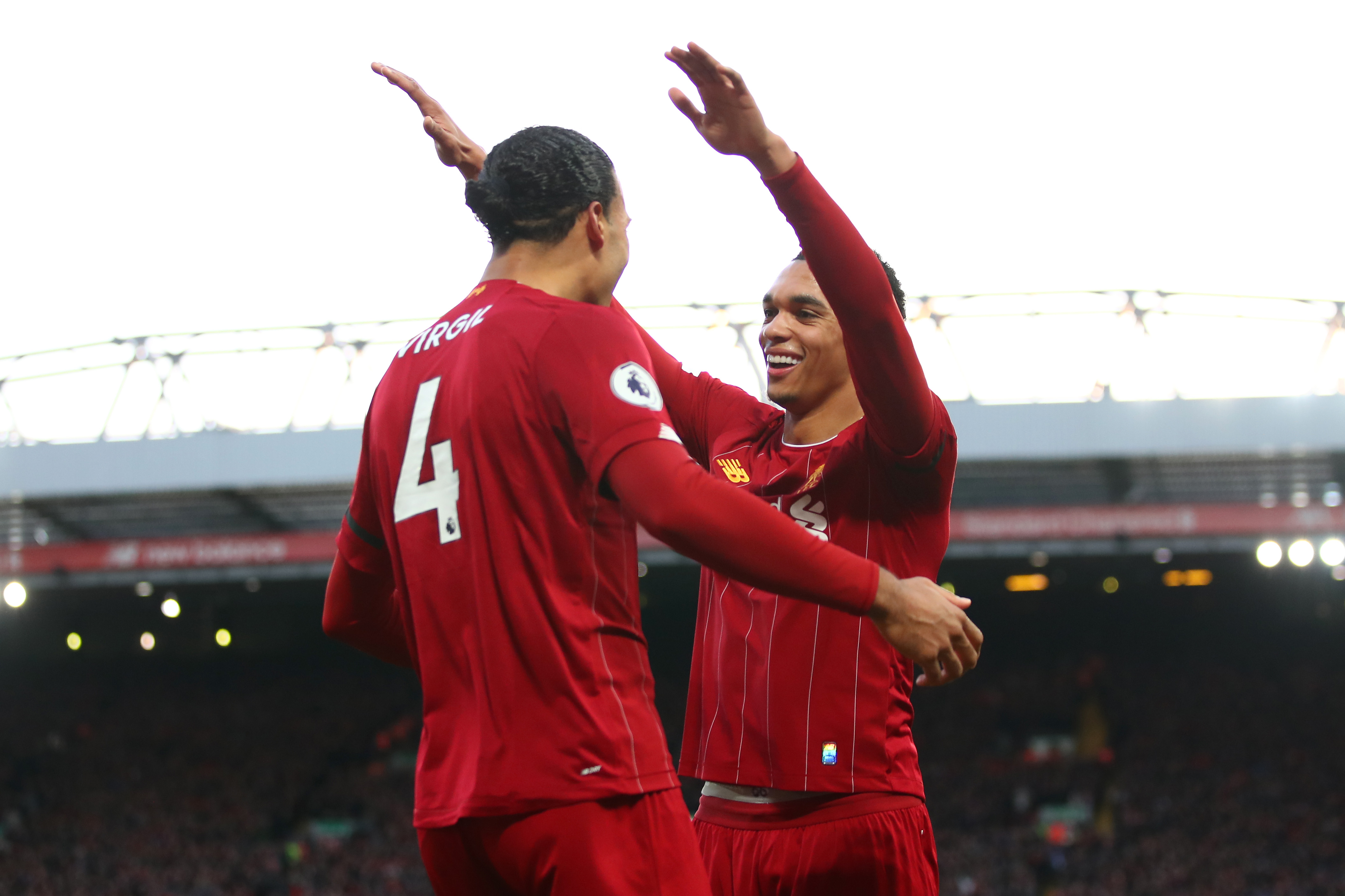 LIVERPOOL, ENGLAND - NOVEMBER 30: Virgil van Dijk of Liverpool celebrates scoring his teams second goal with team mate Trent Alexander-Arnold during the Premier League match between Liverpool FC and Brighton & Hove Albion at Anfield on November 30, 2019 in Liverpool, United Kingdom. (Photo by Clive Brunskill/Getty Images)