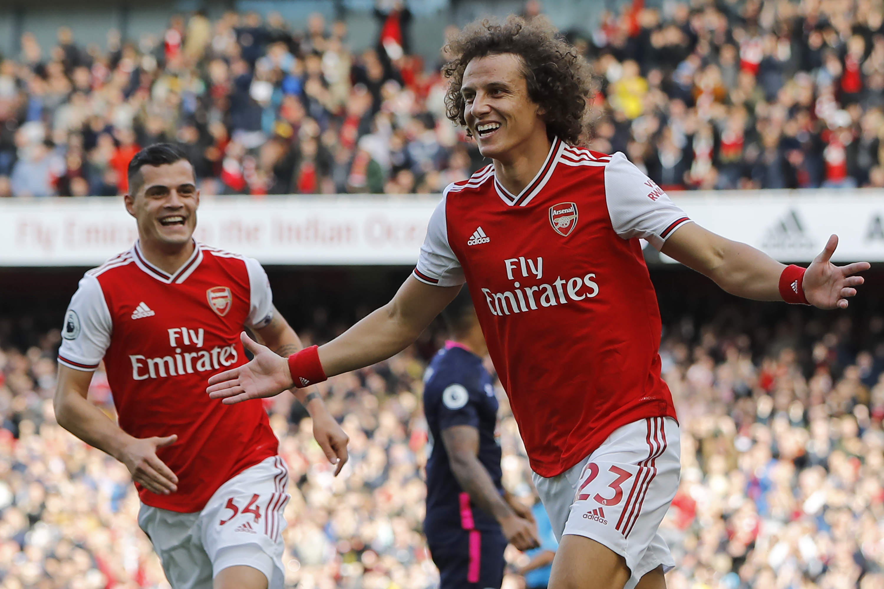 Asenal's Brazilian defender David Luiz (R) celebrates with Arsenal's Swiss midfielder Granit Xhaka (L) after scoring the opening goal of the English Premier League football match between Arsenal and Bournemouth at the Emirates Stadium in London on October 6, 2019. (Photo by Tolga AKMEN / AFP) / RESTRICTED TO EDITORIAL USE. No use with unauthorized audio, video, data, fixture lists, club/league logos or 'live' services. Online in-match use limited to 120 images. An additional 40 images may be used in extra time. No video emulation. Social media in-match use limited to 120 images. An additional 40 images may be used in extra time. No use in betting publications, games or single club/league/player publications. / (Photo by TOLGA AKMEN/AFP via Getty Images)