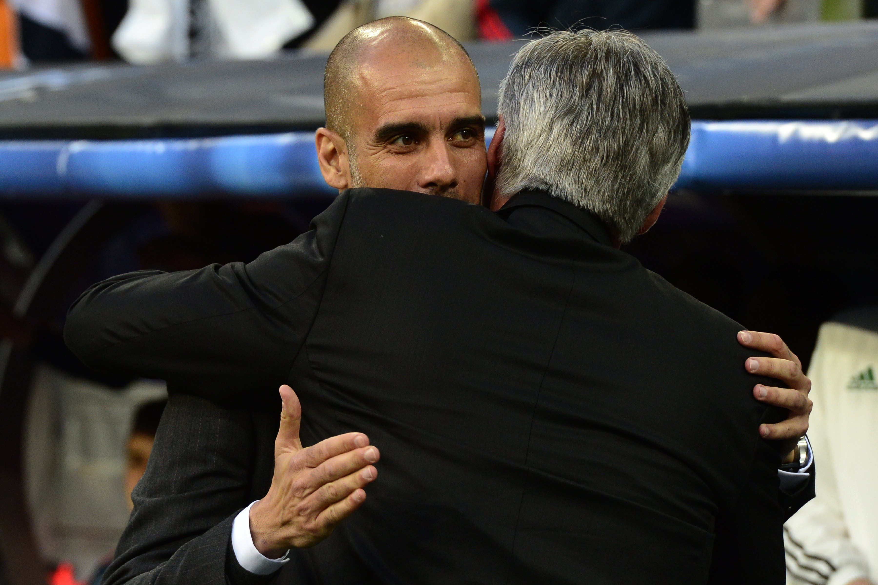 Real Madrid's Italian coach Carlo Ancelotti (R) embraces Bayern Munich's Spanish head coach Pep Guardiola during the UEFA Champions League semifinal first leg football match Real Madrid CF vs FC Bayern Munchen at the Santiago Bernabeu stadium in Madrid on April 23, 2014. AFP PHOTO/ JAVIER SORIANO (Photo credit should read JAVIER SORIANO/AFP via Getty Images)