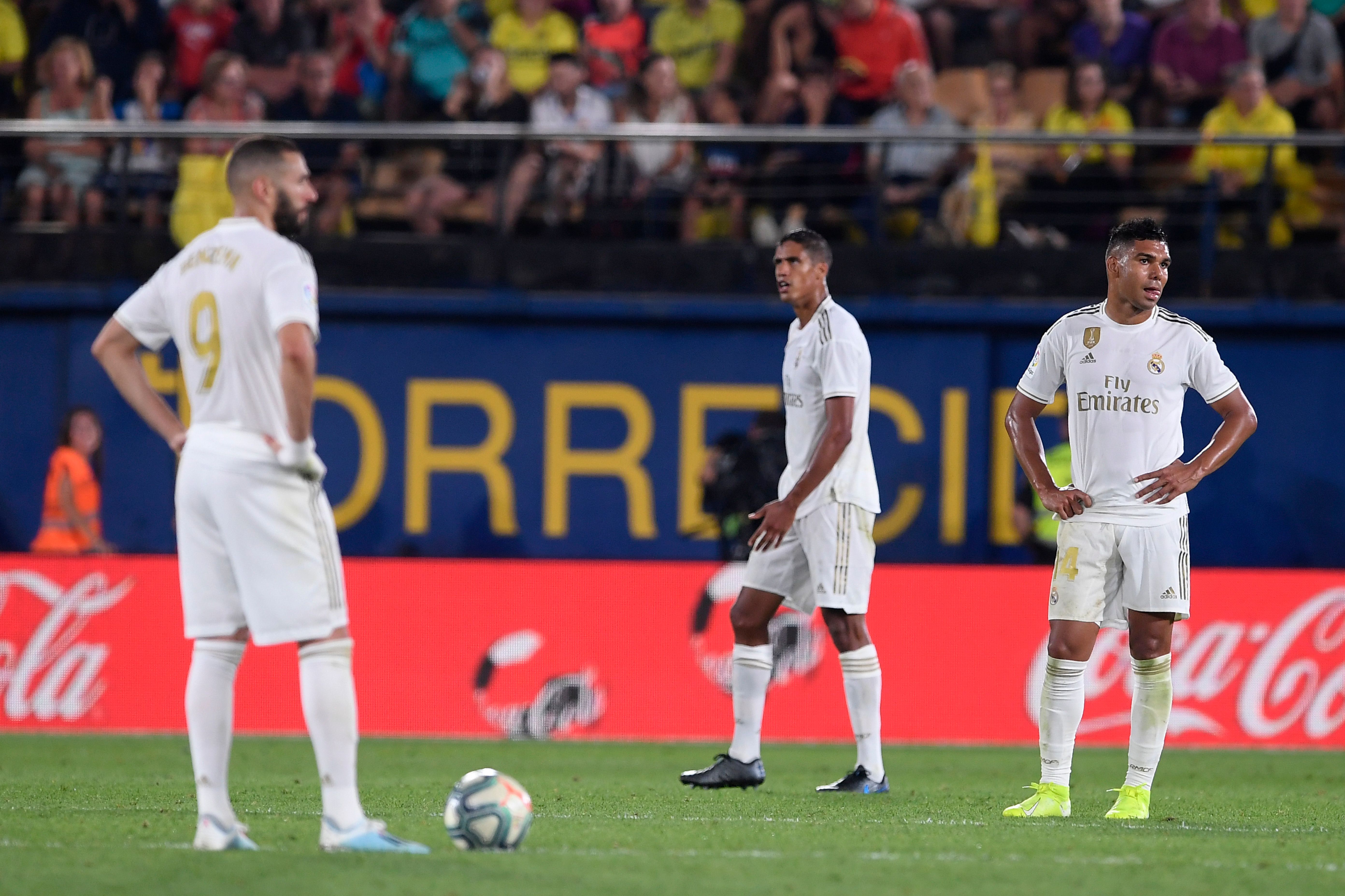 (FromL) Real Madrid's French forward Karim Benzema, Real Madrid's French defender Raphael Varane and Real Madrid's Brazilian midfielder Casemiro react after Villarreal's Spanish midfielder Moises Gomez scored a goal during the Spanish league football match Villarreal CF against Real Madrid CF at La Ceramica stadium in Vila-real on September 1, 2019. (Photo by Josep LAGO / AFP) (Photo credit should read JOSEP LAGO/AFP via Getty Images)