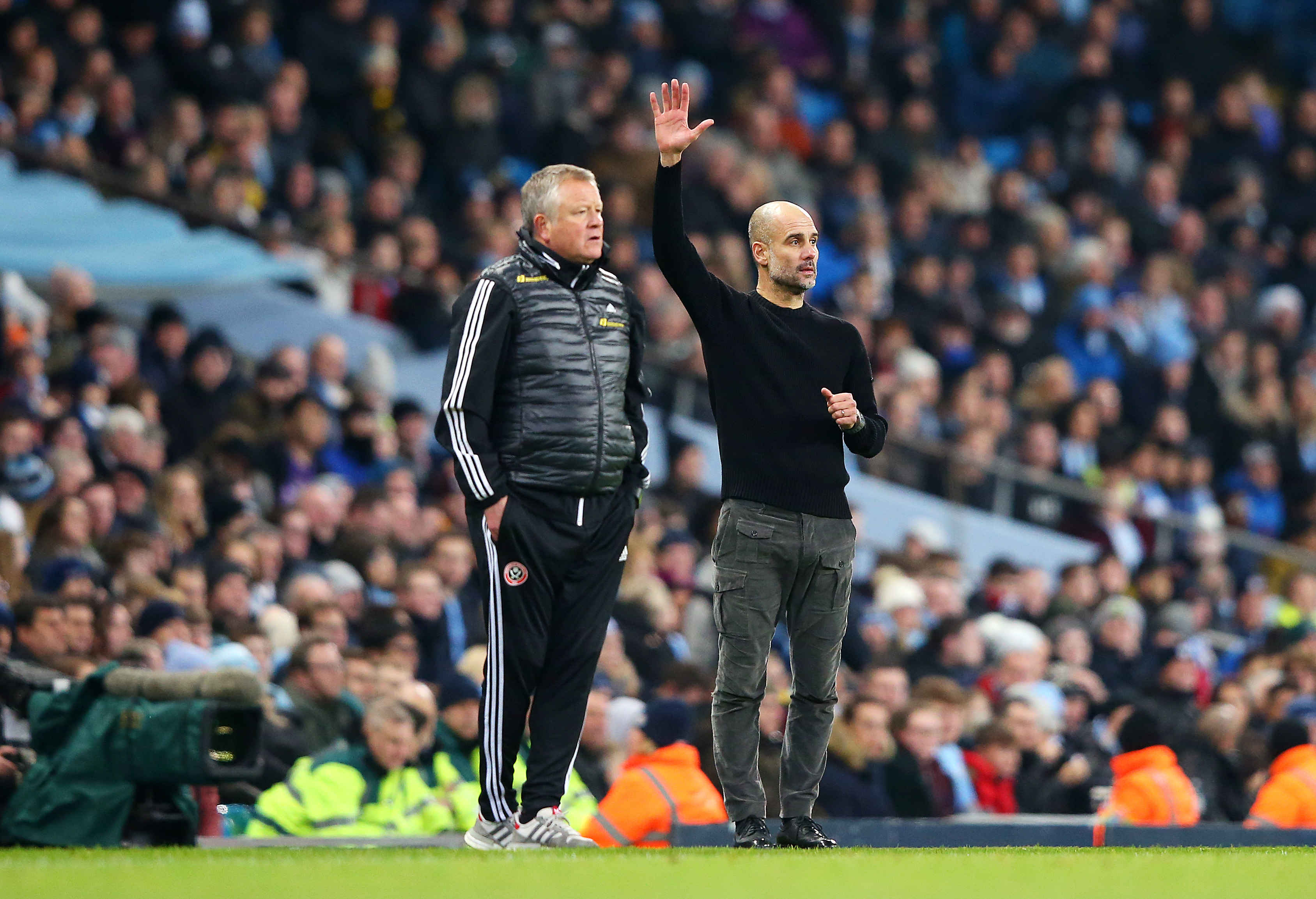MANCHESTER, ENGLAND - DECEMBER 29: Chris Wilder, Manager of Sheffield United and Pep Guardiola, Manager of Manchester City look on during the Premier League match between Manchester City and Sheffield United at Etihad Stadium on December 29, 2019 in Manchester, United Kingdom. (Photo by Alex Livesey/Getty Images)