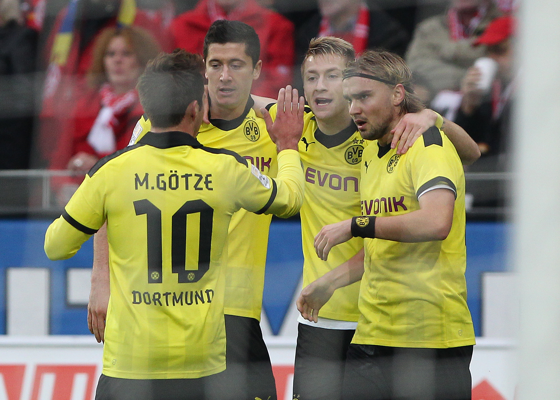 (L-R) Dortmund's midfielder Mario Goetze, Dortmund's Polish striker Robert Lewandowski, Dortmund's striker Marco Reus and Dortmund's defender Marcel Schmelzer celebrate during the German first division Bundesliga football match 1. FSV Mainz 05 vs Borussia Dortmund in Mainz, southwestern Germany, on November 24, 2012. AFP PHOTO / DANIEL ROLAND

RESTRICTIONS / EMBARGO - DFL RULES TO LIMIT THE ONLINE USAGE DURING MATCH TIME TO 15 PICTURES PER MATCH. IMAGE SEQUENCES TO SIMULATE VIDEO IS NOT ALLOWED AT ANY TIME. FOR FURTHER QUERIES PLEASE CONTACT DFL DIRECTLY AT + 49 69 650050.        (Photo credit should read DANIEL ROLAND/AFP via Getty Images)