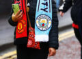 A fan wearing a half and half scarf Manchester United, ManU v Manchester City, Premier League, Football, Old Trafford, Manchester, UK - 17 Jan 2026Manchester Old Trafford United Kingdom EDITORIAL USE ONLY No use with unauthorised audio, video, data, fixture lists, club/league logos or live services. Online in-match use limited to 120 images, no video emulation. No use in betting, games or single club/league/player publications. PUBLICATIONxINxGERxSUIxAUTxHUNxGRExMLTxCYPxROUxBULxUAExKSAxCHNxDENxINDxITAxPORxESPxSWExTURxMEXxCOLxVENxPERxECUxBRAxARGxCHIxURUxPARxPANxONLY Copyright: xMattxWest/Shutterstockx 16347907bw